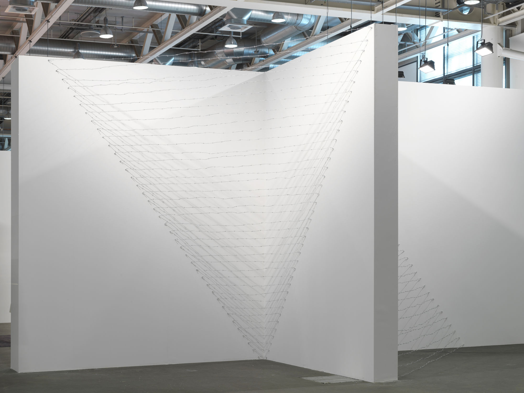 Installation view: Melvin Edwards: Pyramid Up and Down Pyramid ( (1969/2012), Barbed wire, dimensions variable, Alexander Gray Associates, Art Unlimited Art 43 Basel, 2012