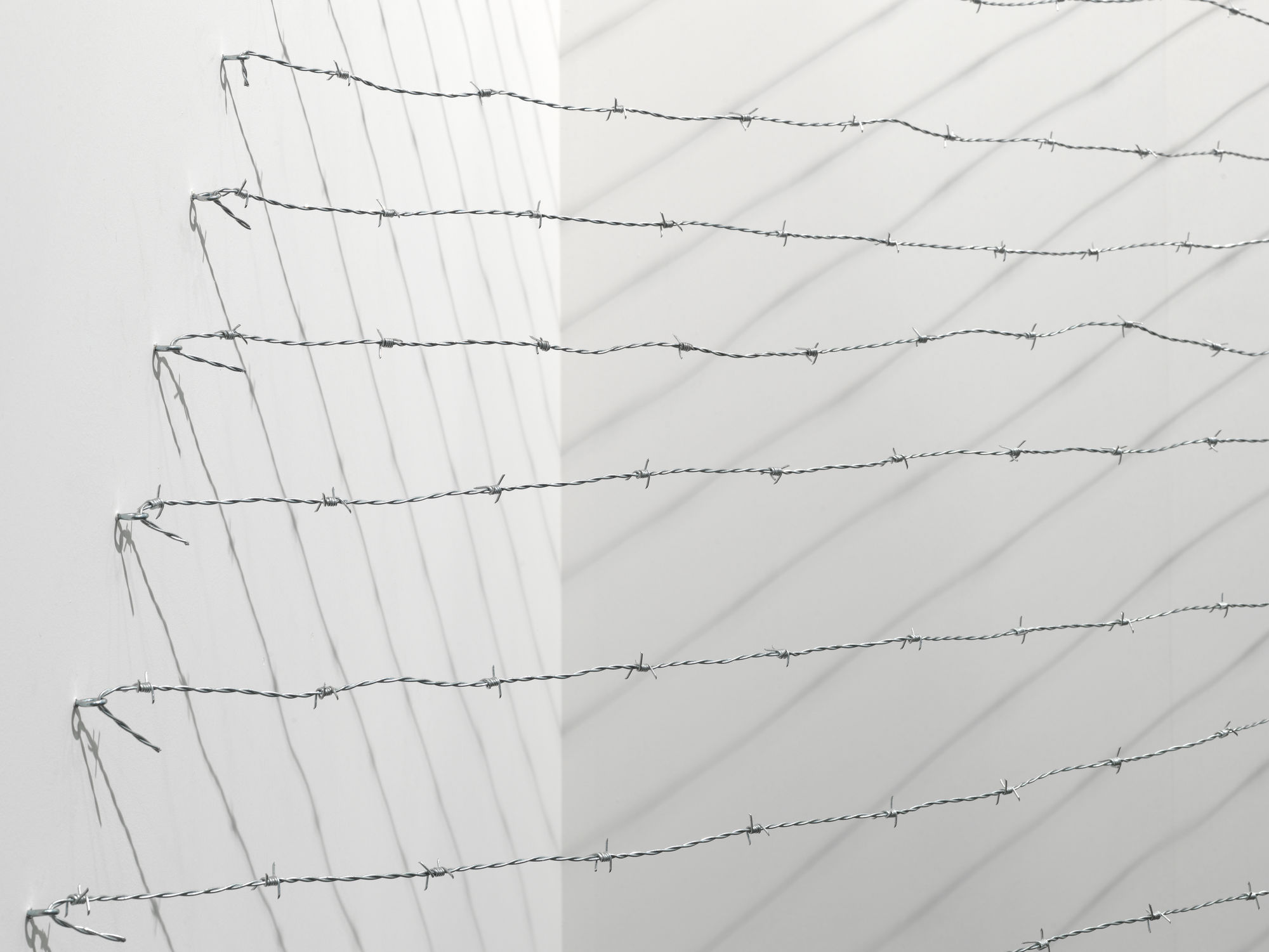 Installation view: Melvin Edwards: Pyramid Up and Down Pyramid ( (1969/2012), Barbed wire, dimensions variable, Alexander Gray Associates, Art Unlimited Art 43 Basel, 2012