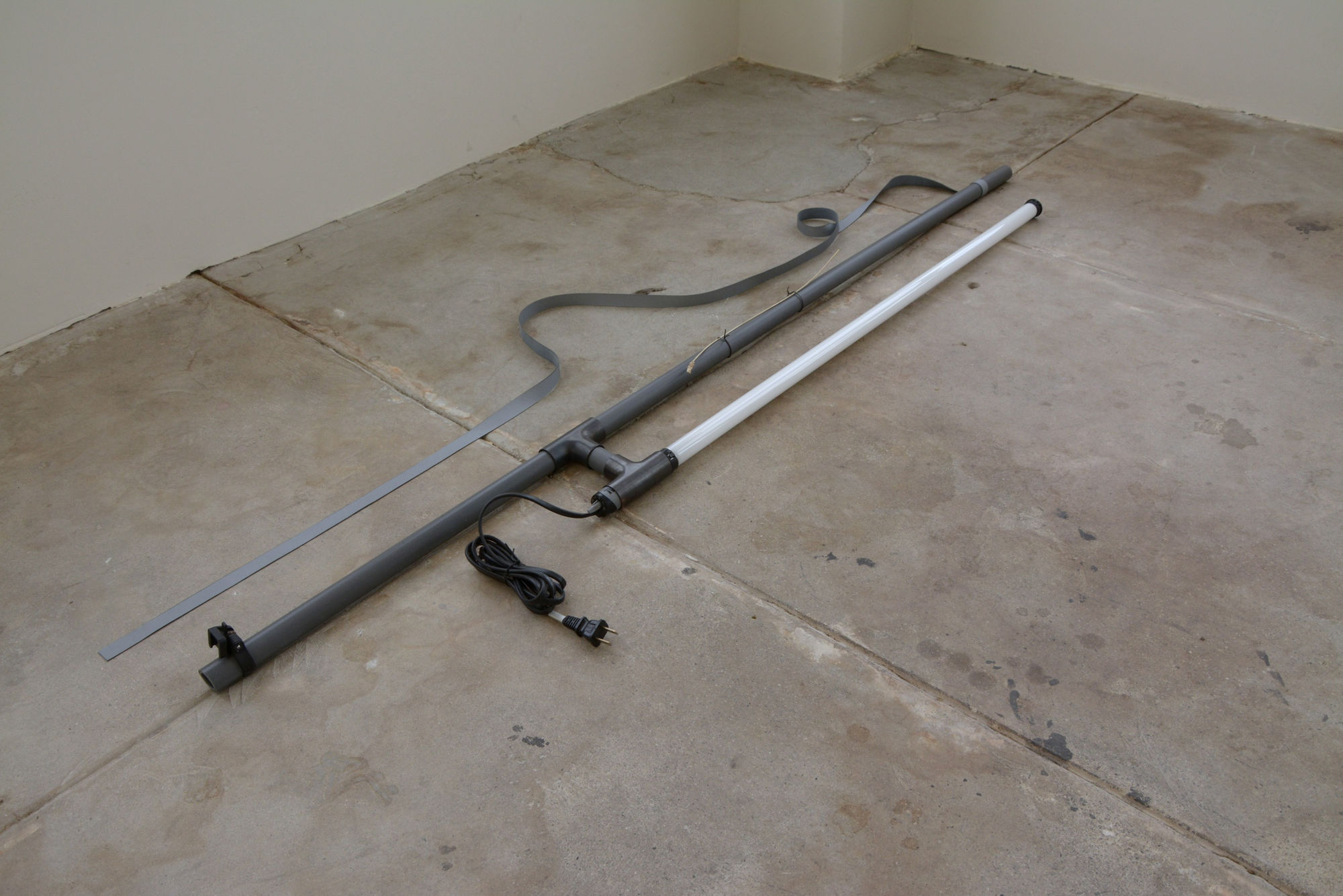 K.r.m. Mooney Joan Green, Bimetal I, 2014 Polyvinyl chloride conduit, copper union fittings, liver of sulfur, electrical splicing vinyl, cast lavender, silver, linear fluorescent, aquatic tank heating components, steel wire, bronzite bead 5 x 16 x 42 in 12.7 x 40.6 x 106.7 cm