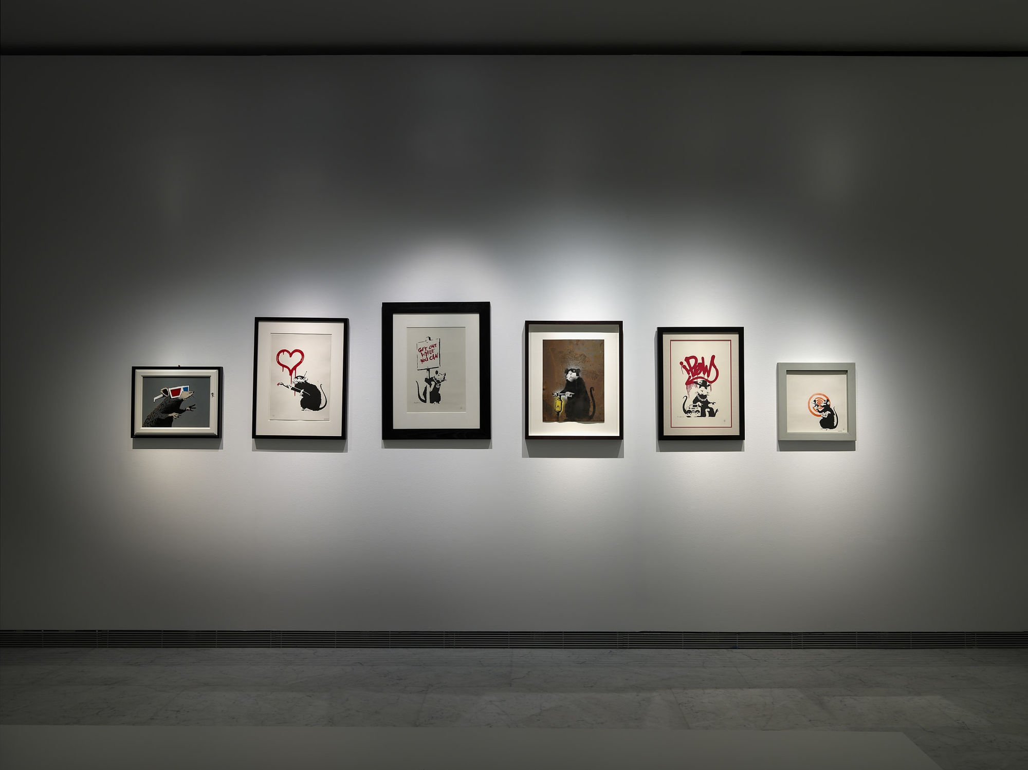 Banksy Exhibition installation, Prints hanging on the walls.