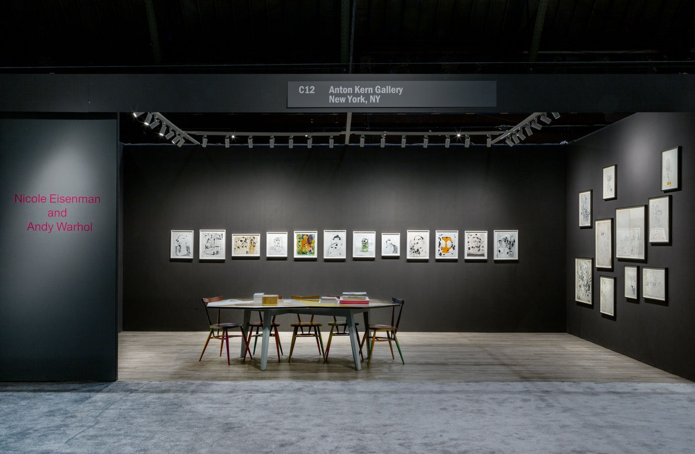 Nicole Eisenman and Andy Warhol dual booth at ADAA. Dark walls populated with drawings by the two artists.