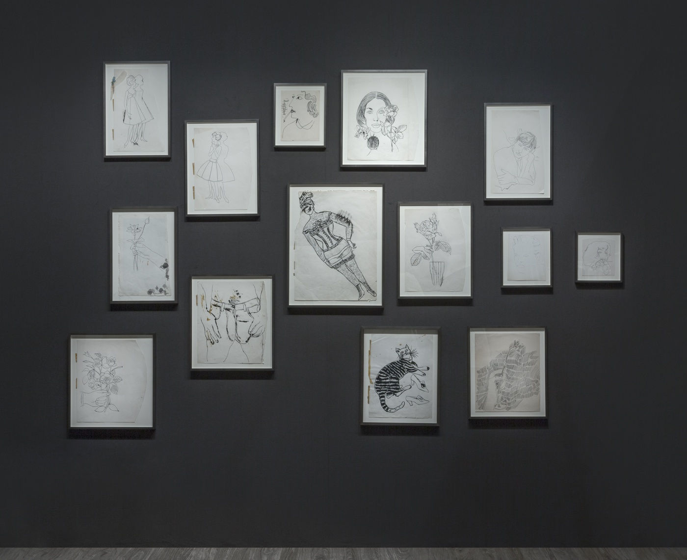 Nicole Eisenman and Andy Warhol dual booth at ADAA. Dark walls populated with drawings by the two artists.