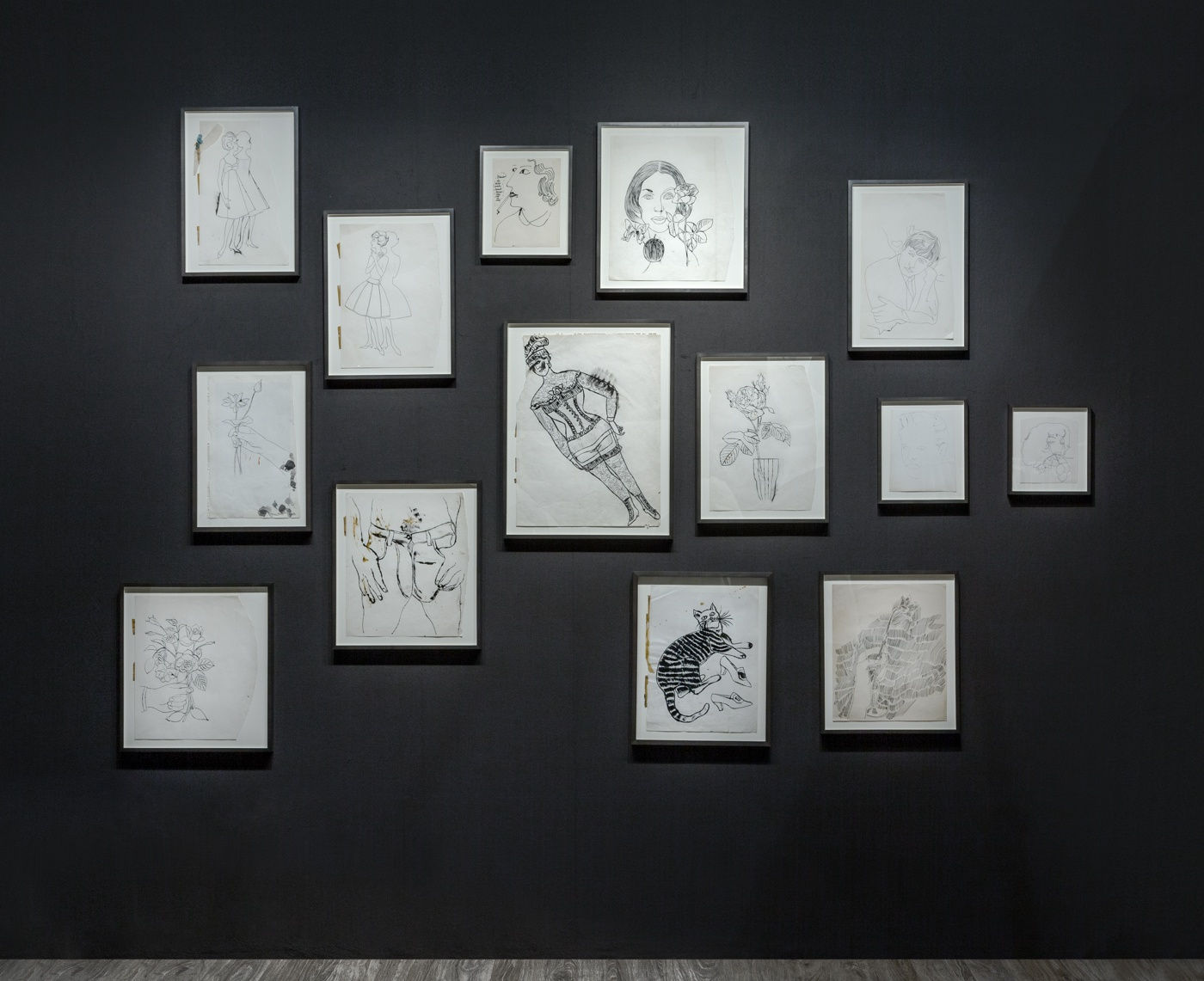 Nicole Eisenman and Andy Warhol dual booth at ADAA. Dark walls populated with drawings by the two artists.