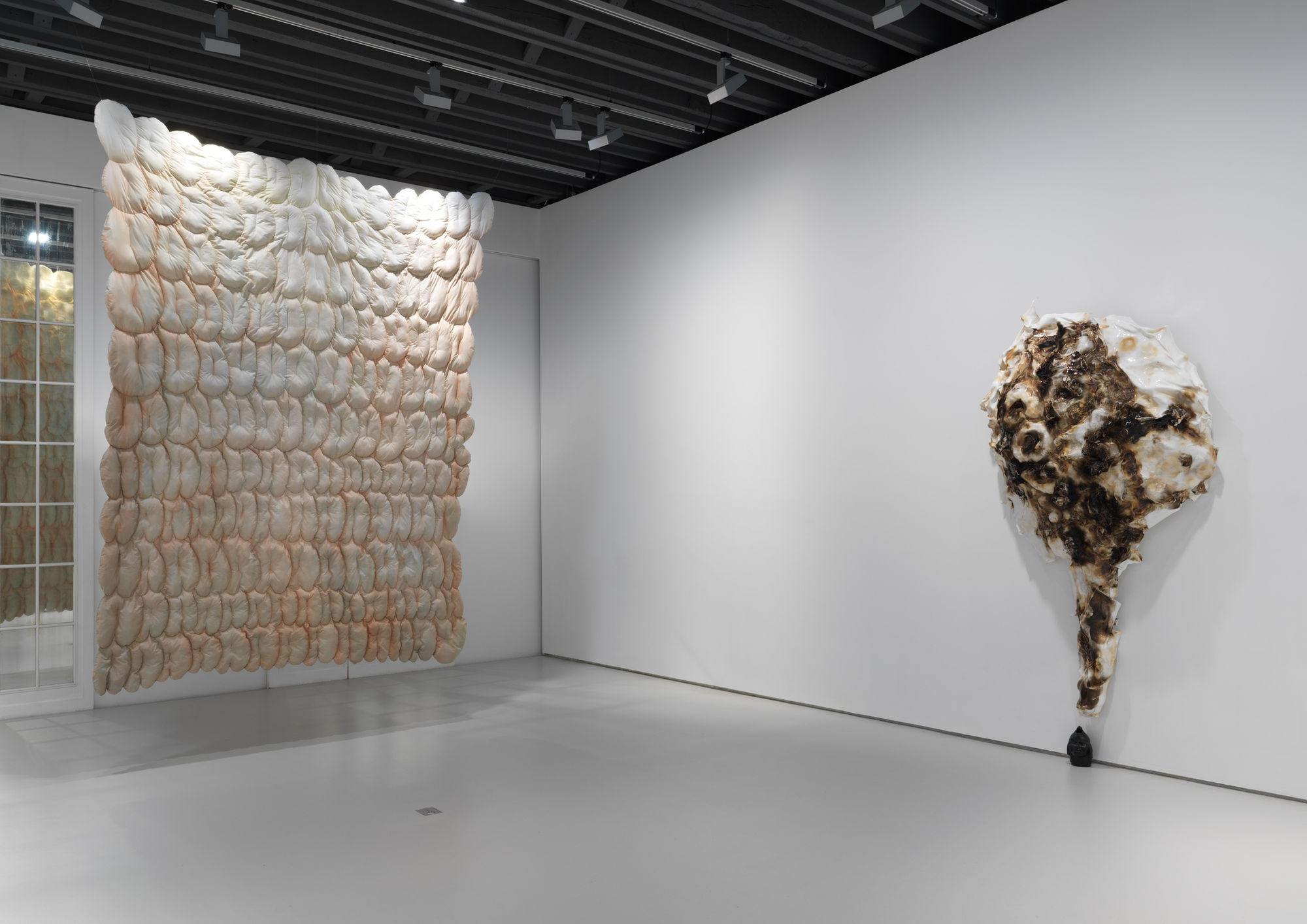 Installation views of the many sculptural works in Richard Hughes' solo exhibition at the gallery. Daydreaming Whilst Peeing, a large piece of stitched fabric hangs in this image.