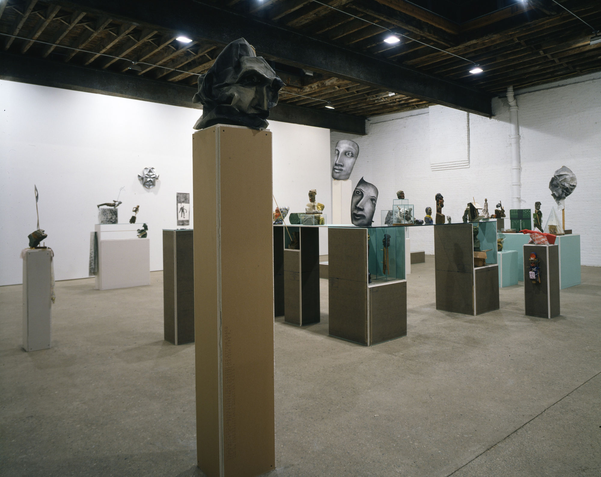Installation view of Matthew Monahan's second solo show at Anton Kern Gallery., featuring curiosities, artifacts, drawings, and assembled sculptures. Detail of one of many Monahan's faces.
