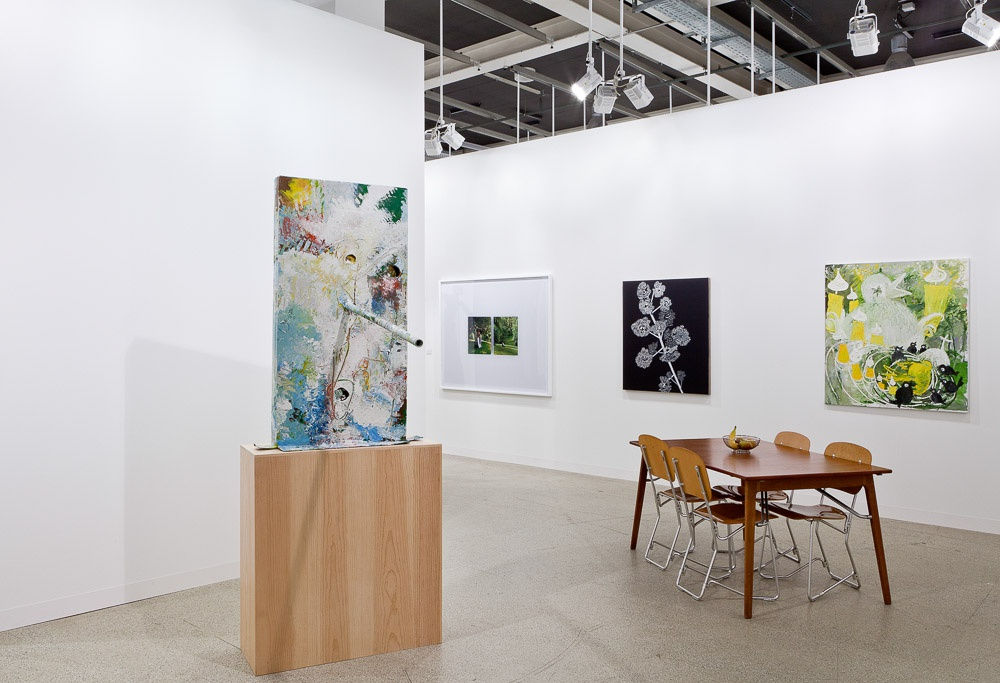 Installation view of Art Basel 2015. Another angle of Grotjahn's standing painting with some works featured in the back.
