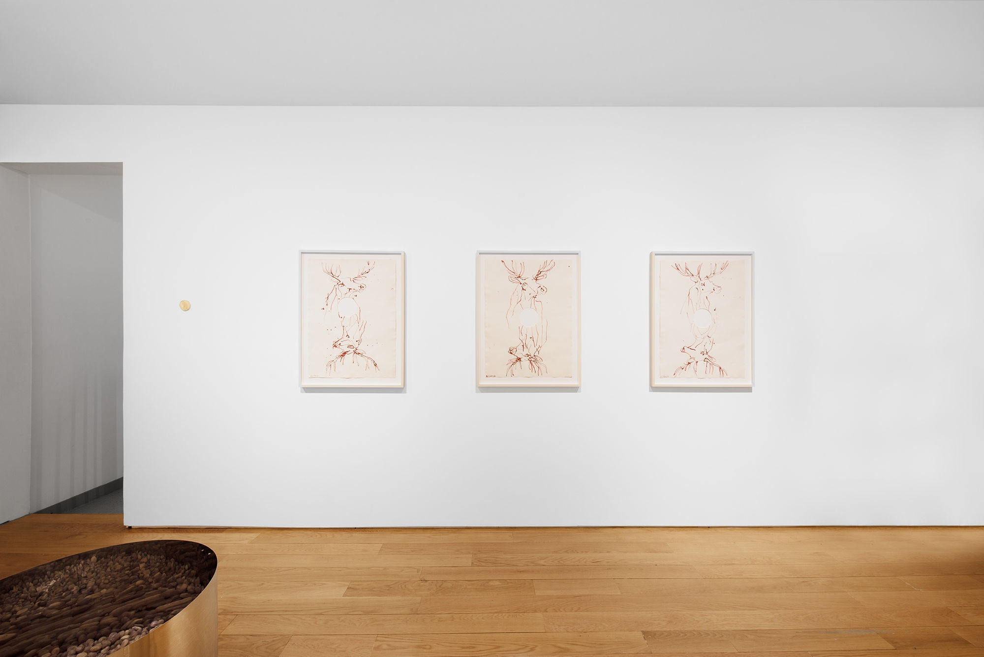 Installation view of the 2023 exhibition “Tondo” with view of wood floors, walls, artworks and ceiling.