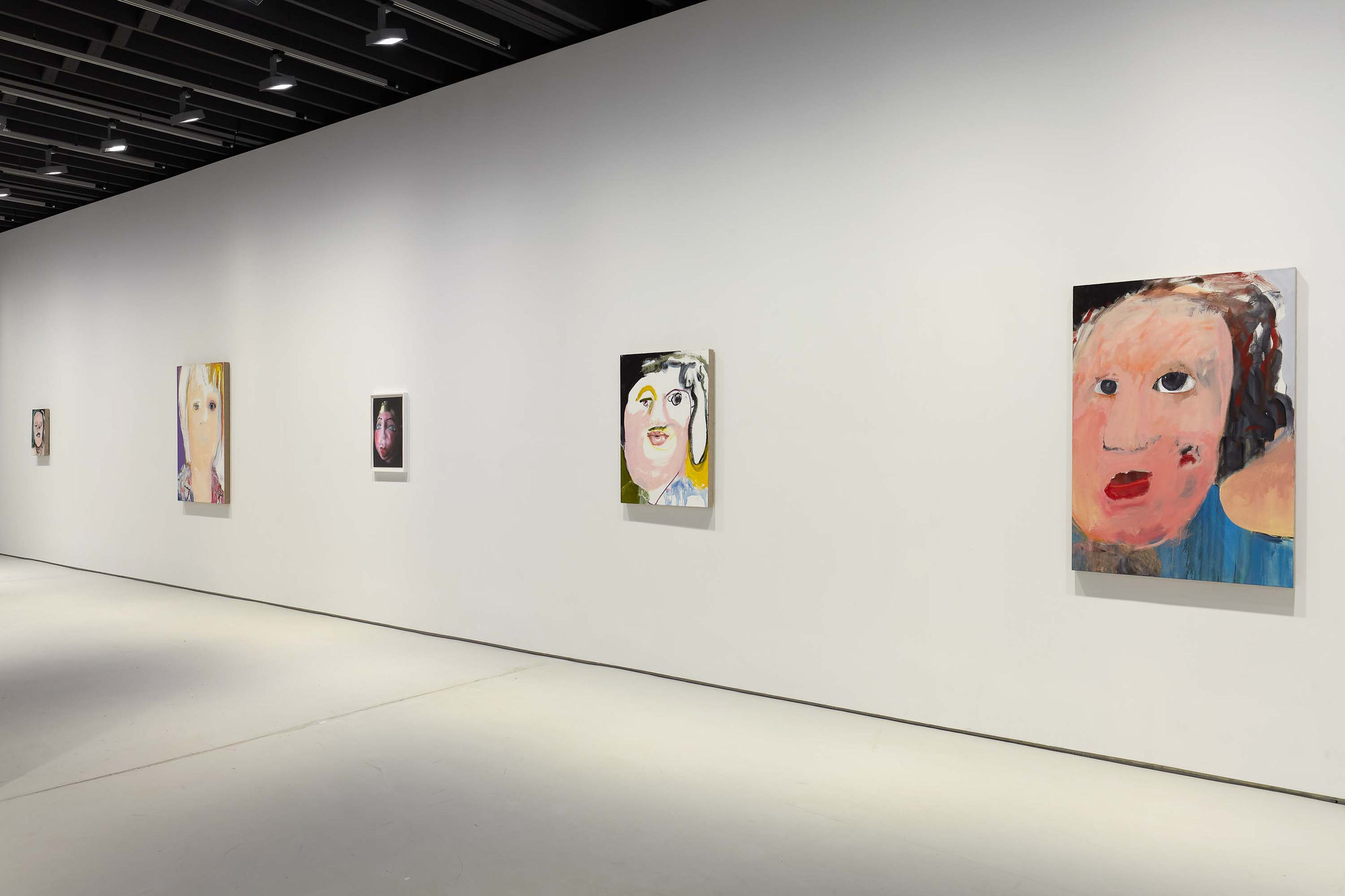 Installation view of figurative portrait paintings made by Margot Bergman.