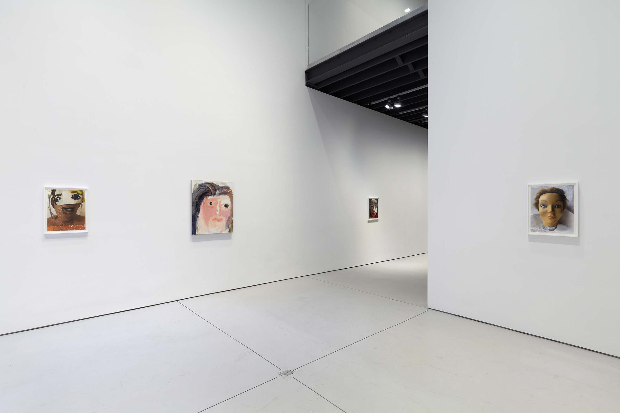 Installation view of figurative portrait paintings made by Margot Bergman. Two works featured here.