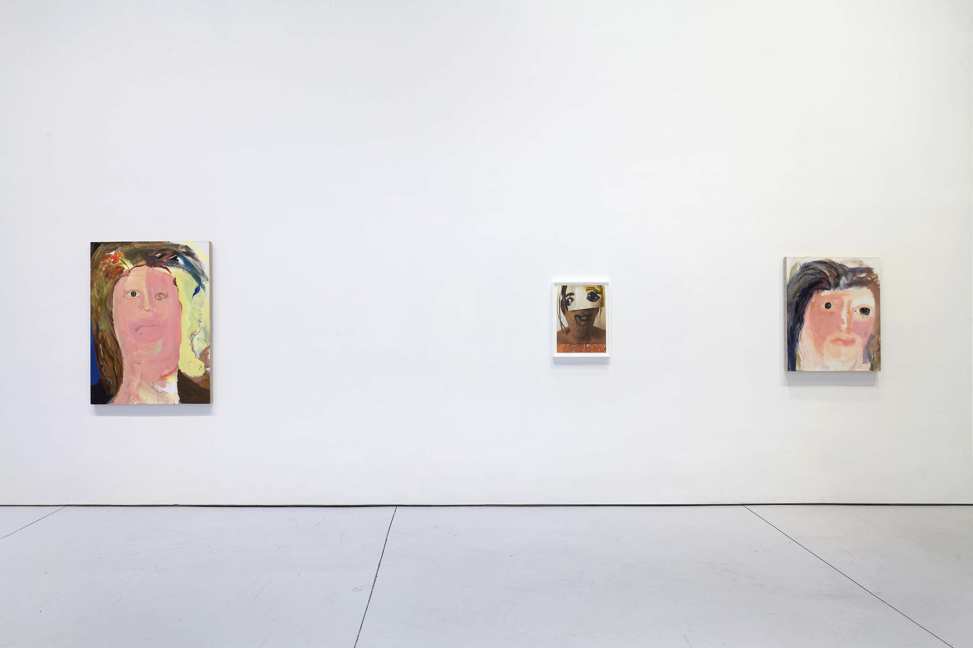 Installation view of figurative portrait paintings made by Margot Bergman. Three small works presented.