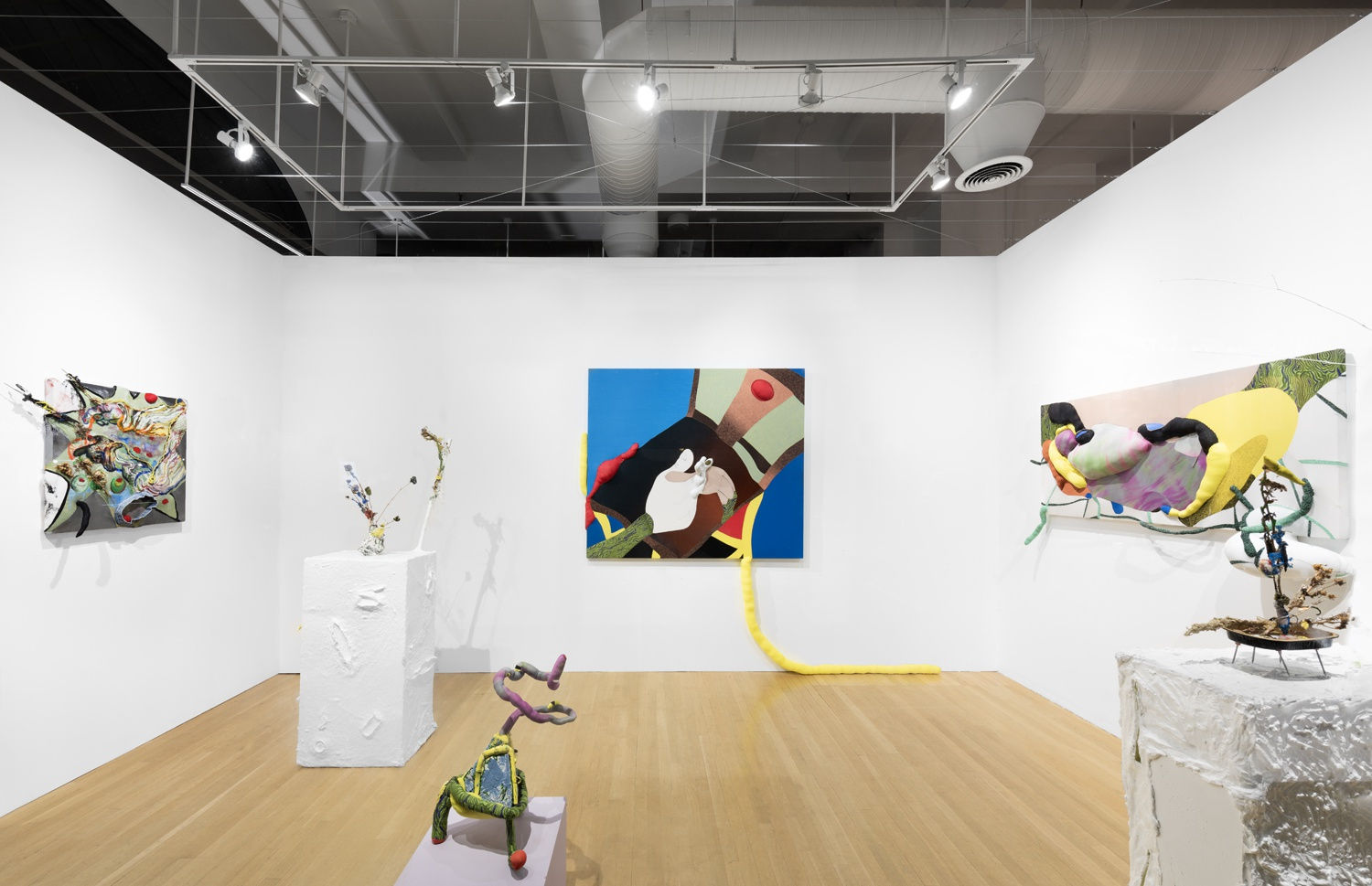Installation view of the 2023 exhibition “Yuli Yamagata: The new, the old, and the hole” with view of wood floors, walls, artworks and ceiling.
