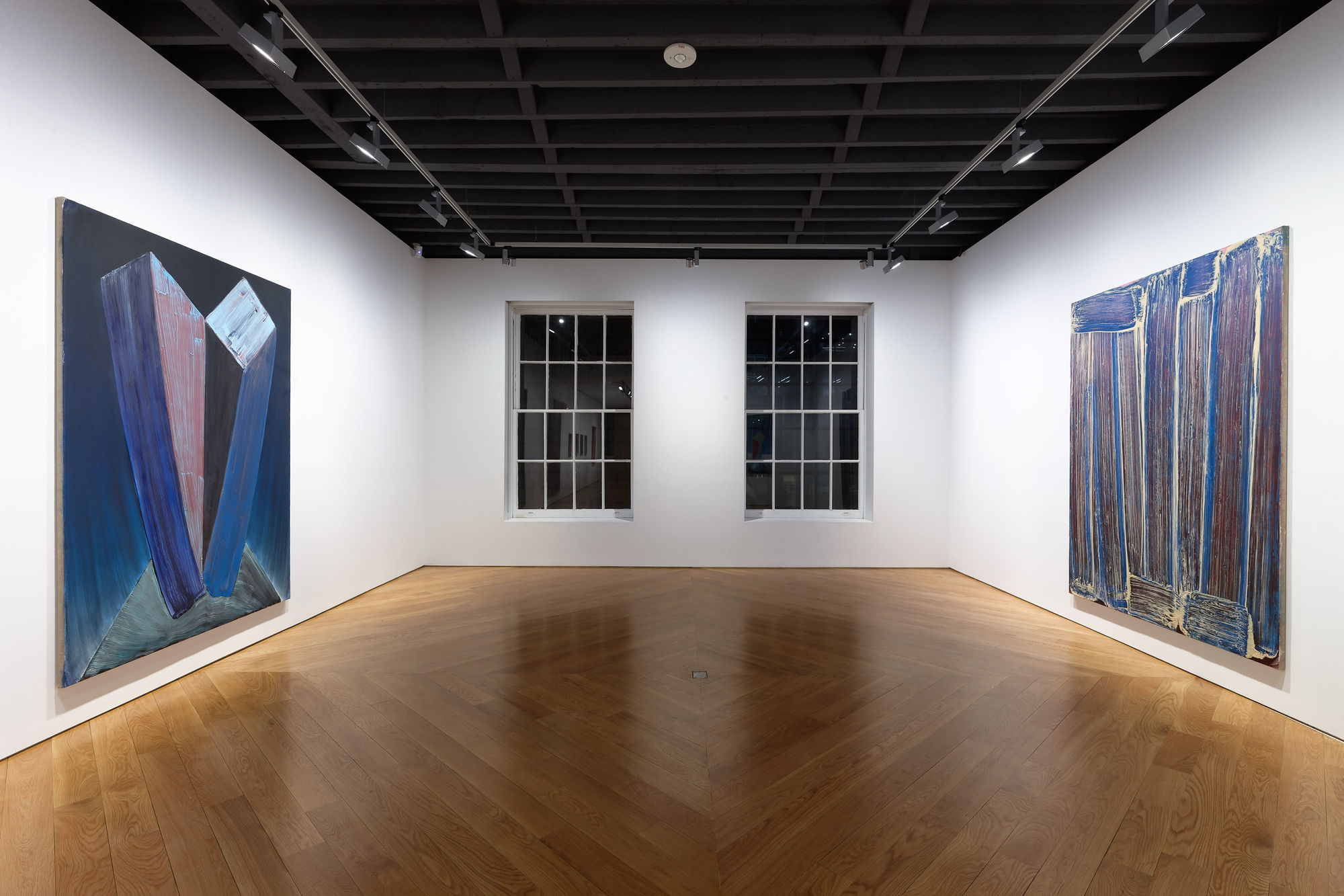 Installation view of Richard Janitz's exhibition at the gallery featuring colorful paintings of gradient color on stretched linen. Two large works featured.