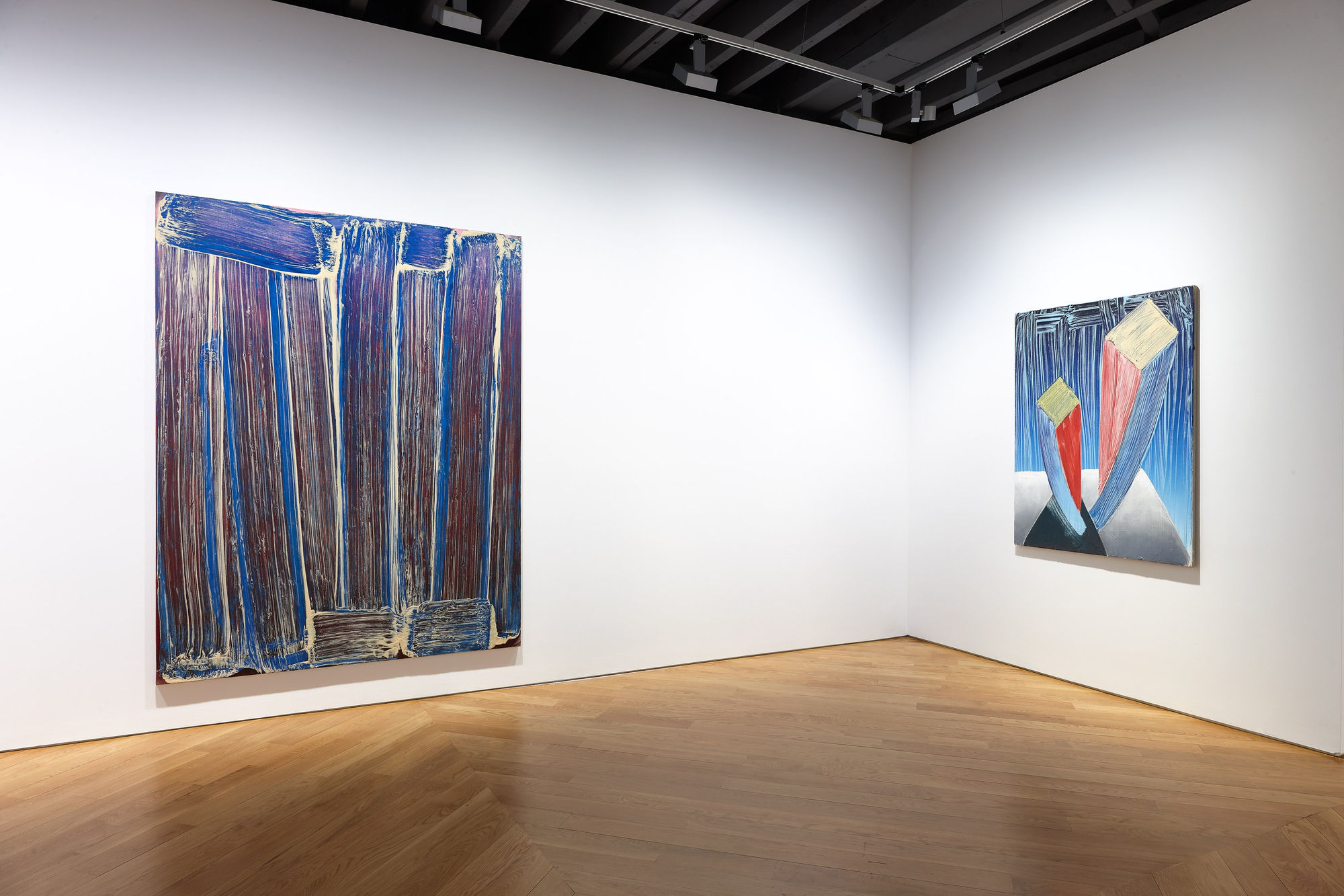 Installation view of Richard Janitz's exhibition at the gallery featuring colorful paintings of gradient color on stretched linen. Two works featured in this image.