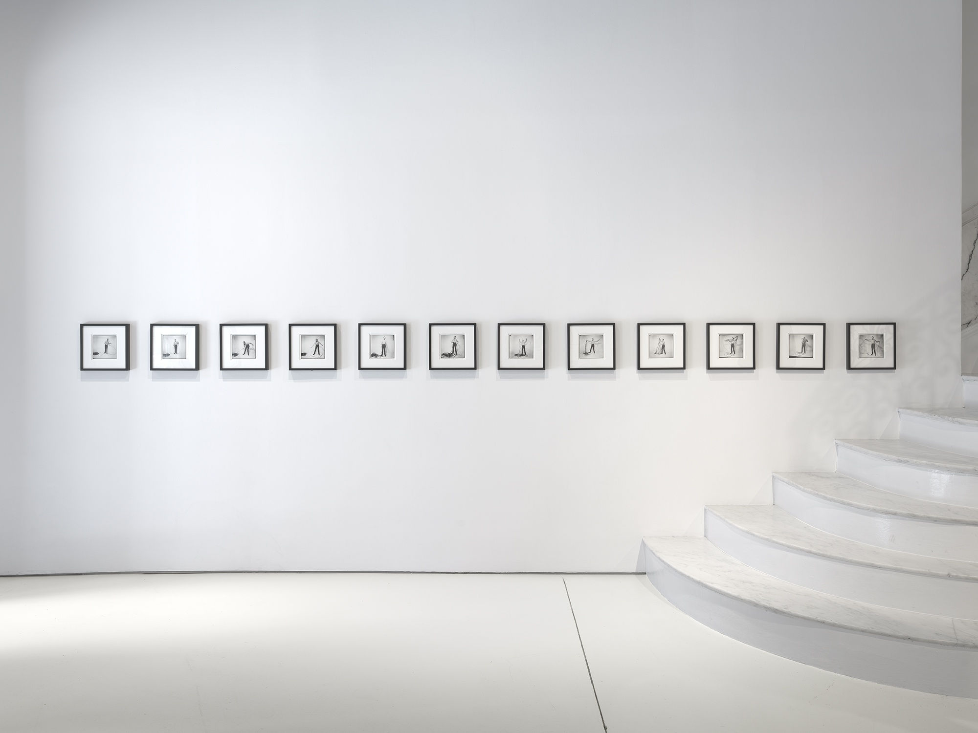 Framed photo works by the stairs.