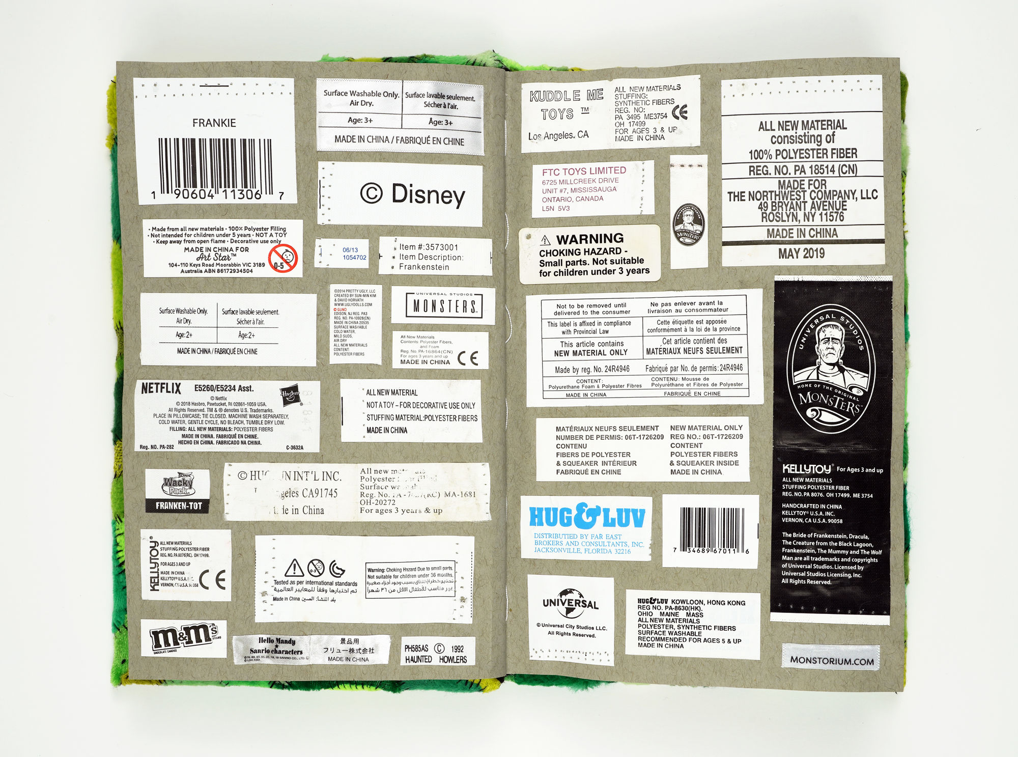 Sungho Bae Codex: Archiving the New Mythos, 2024 Fabrics from plush toys of various Frankenstein’s monsters, product tags, One eye extracted from the left side of a Frankenstein monster toy, Threads extracted from a Frankenstein monster toy 9 x 6 x 1 inches
