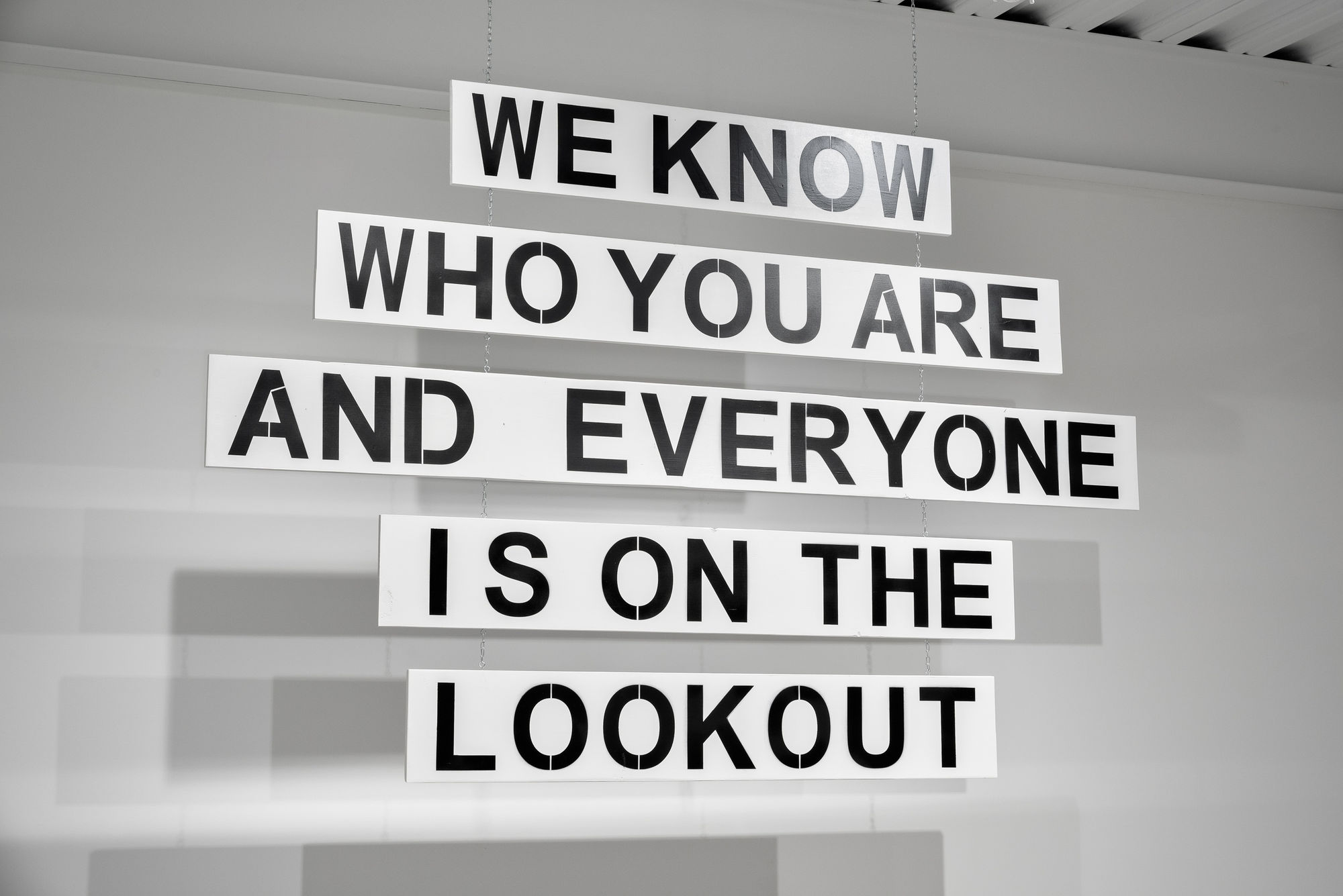 WE KNOW WHO YOU ARE AND EVERYONE IS ON THE LOOKOUT, 2024 Wood, house paint, steel chain 60 x 89 x 3/4 inches