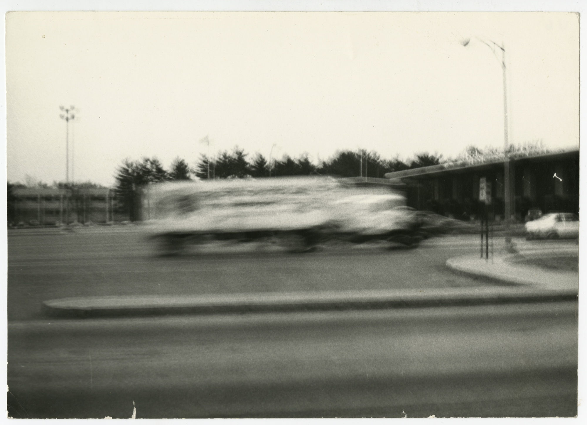 Black and white blurry image of a school bus