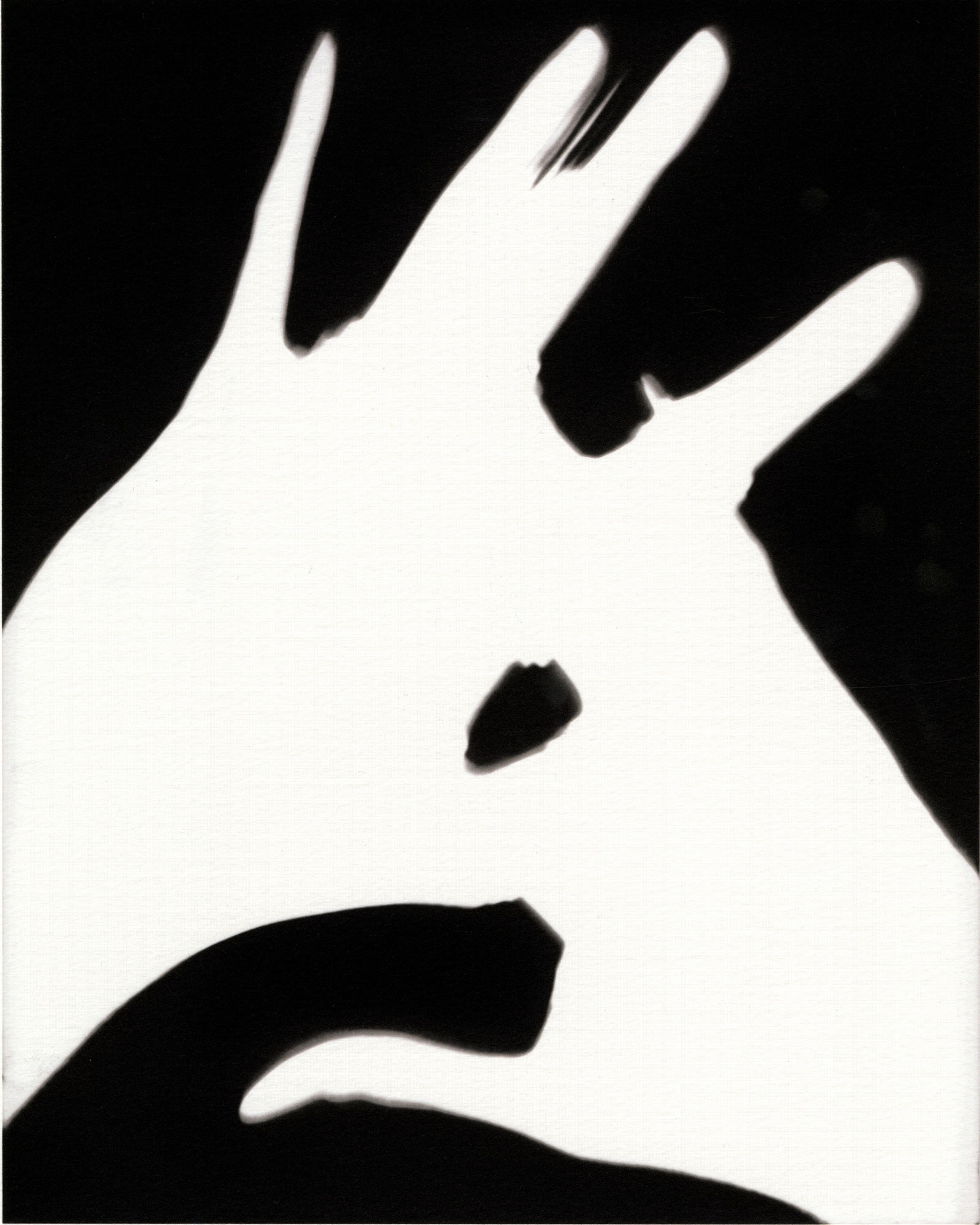 Black and white silhouette of touching hands