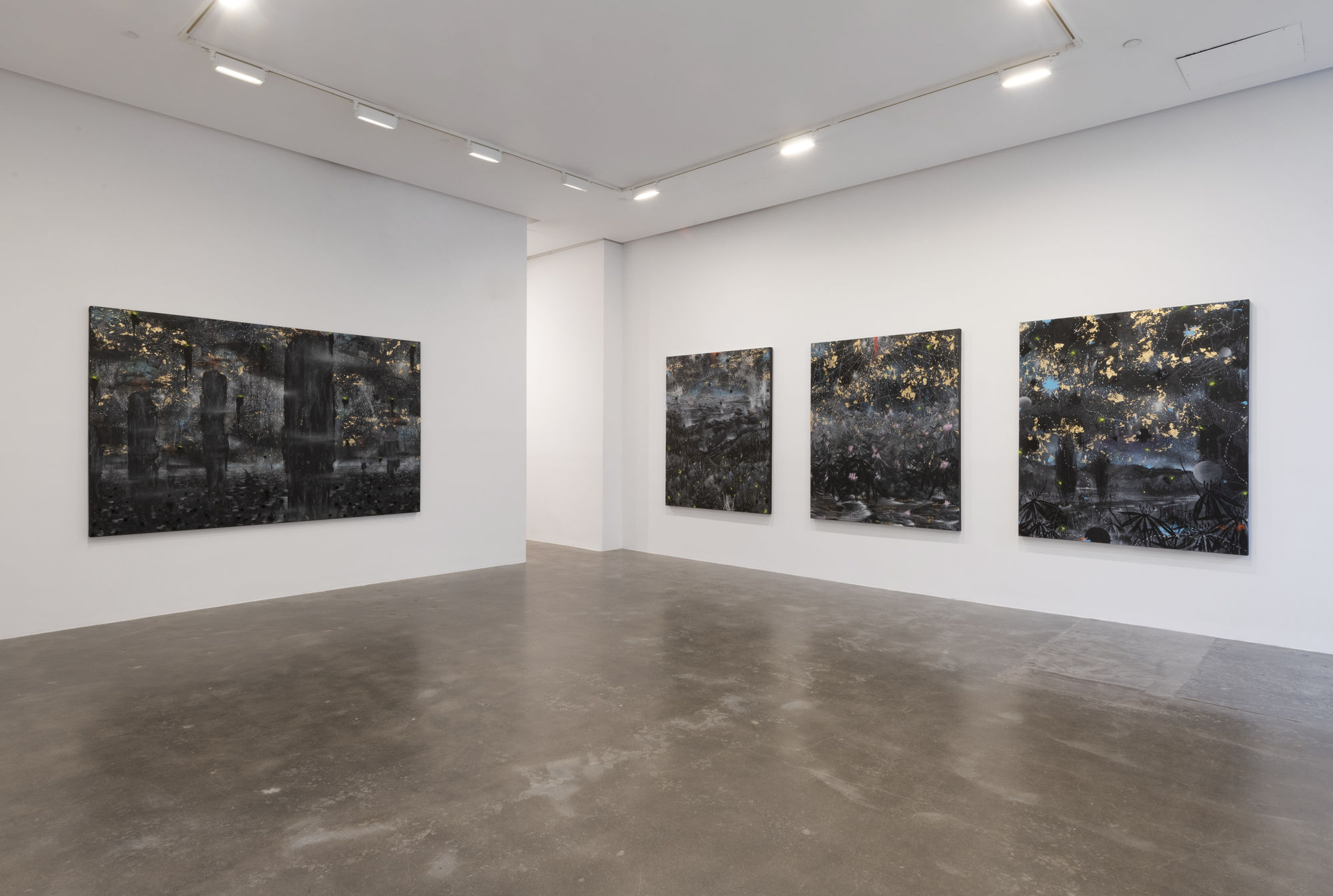 Installation view of four large black and gold paintings by Michi Meko