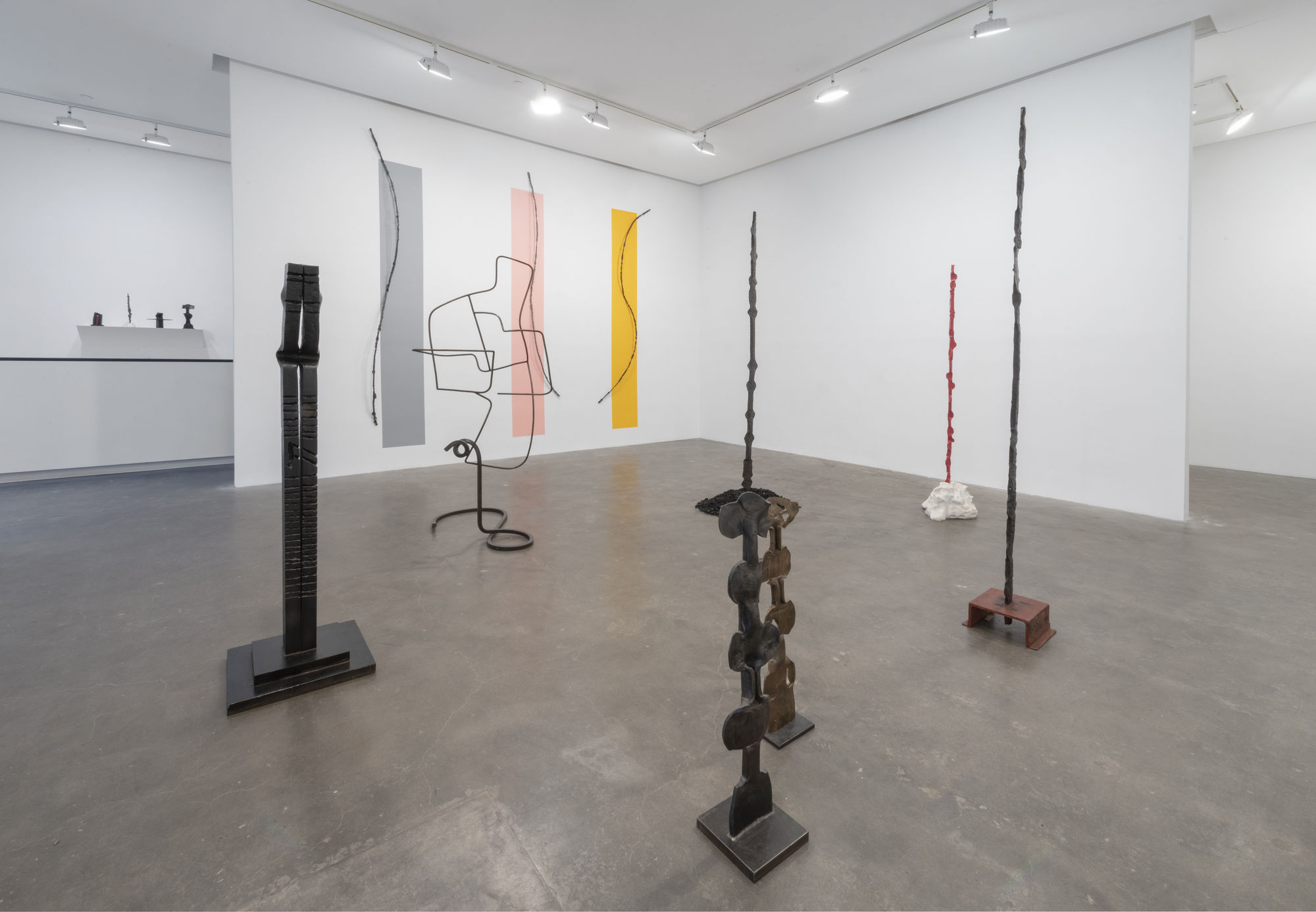 Installation View of Susan Inglett Gallery with many large vertical sculptures by Alain Kirili