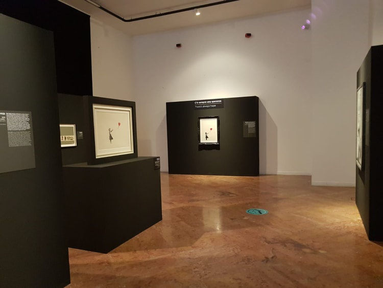 Banksy artworks hanging on wall