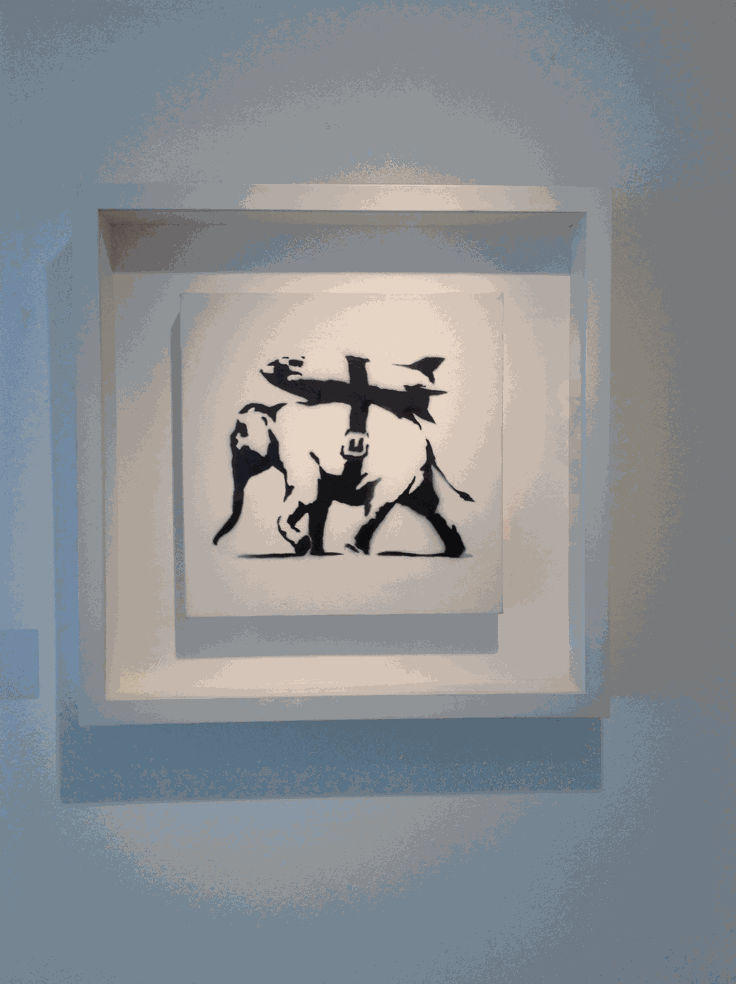 Banksy artwork hanging on wall