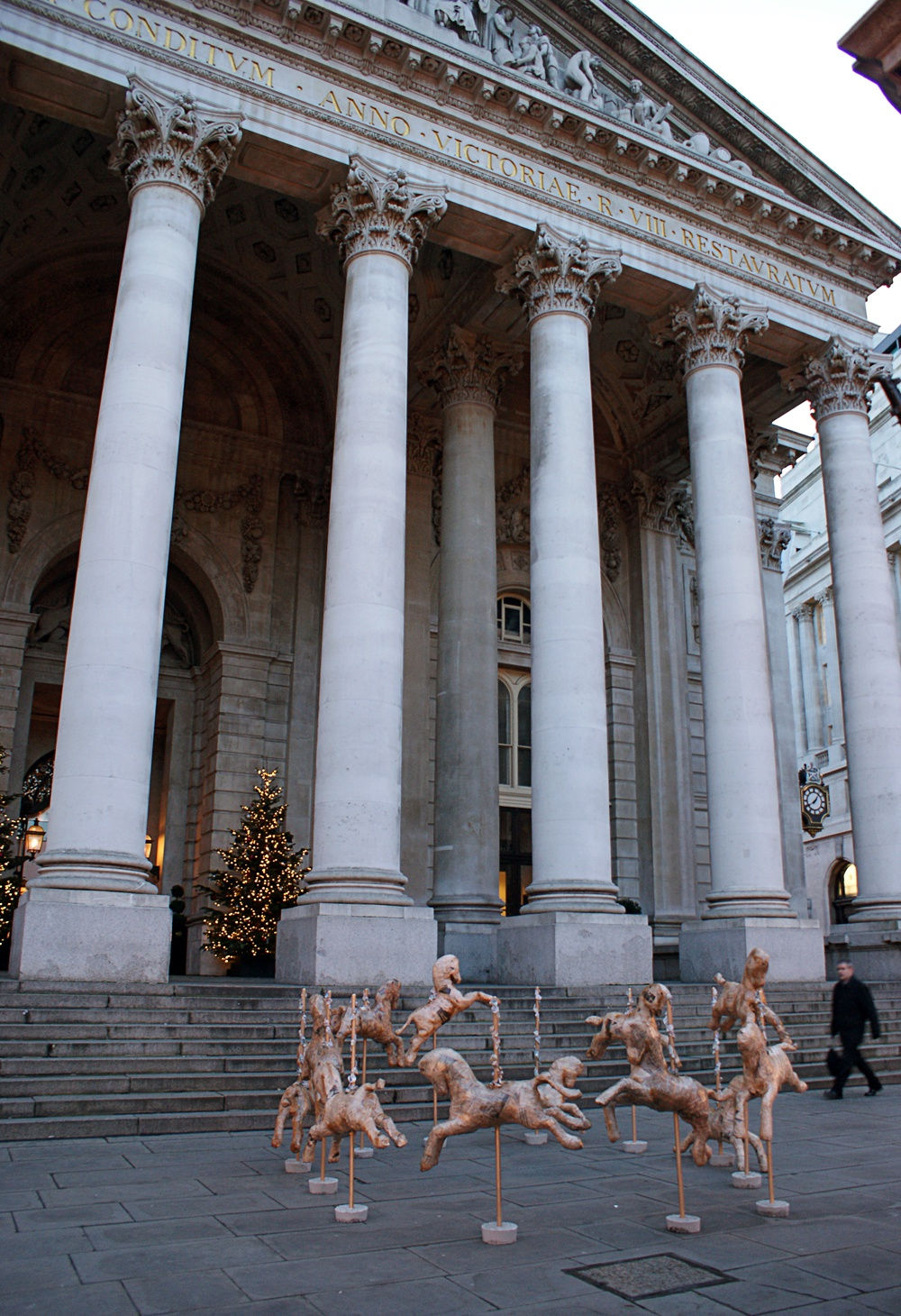 Laura Keeble Money Makes the World Go Round Carousel horses outside londons financial district