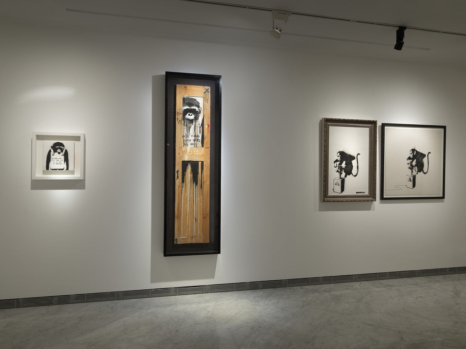 Banksy artworks hanging on wall