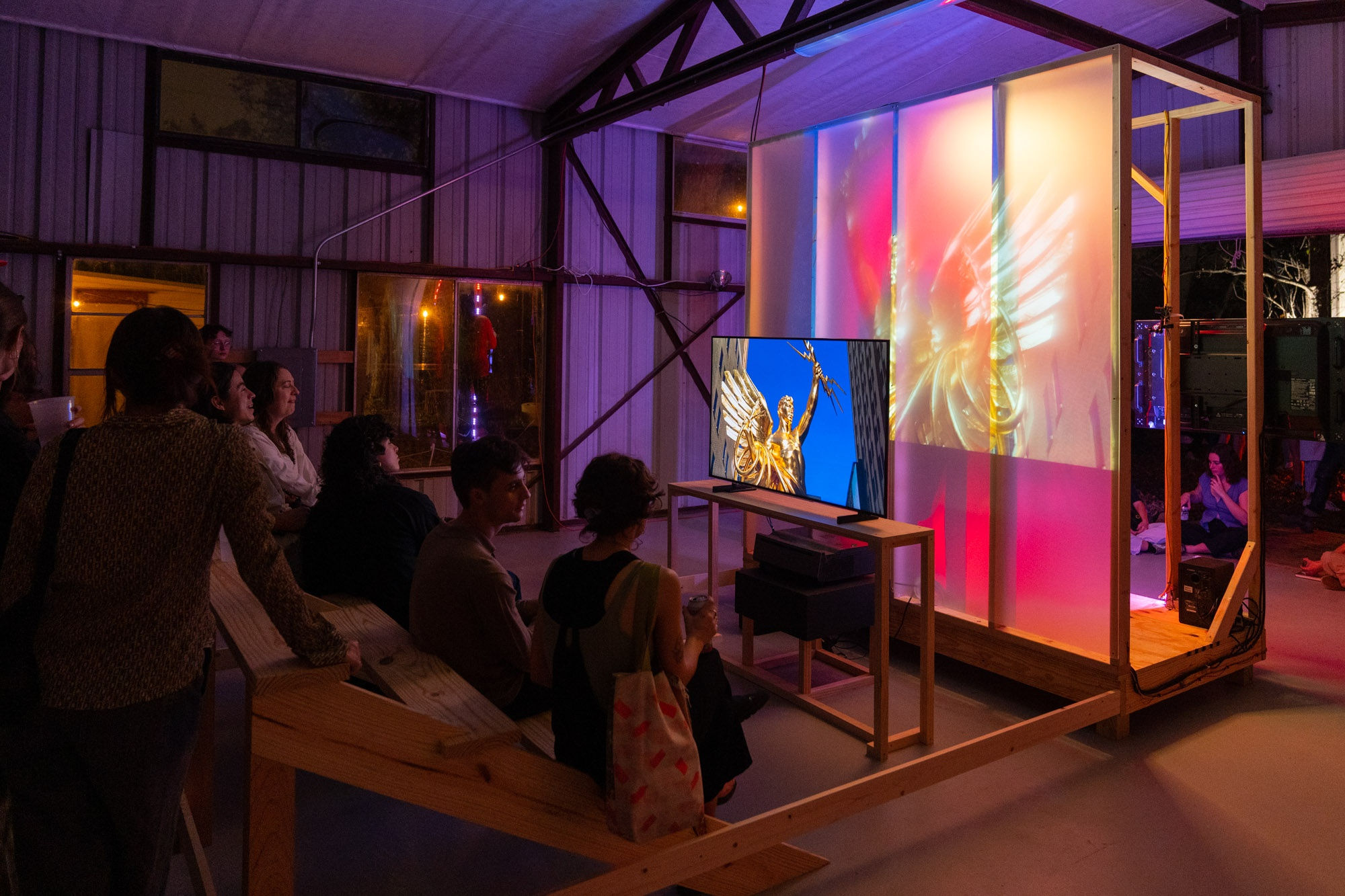 group of people looking at video by Trey Burns