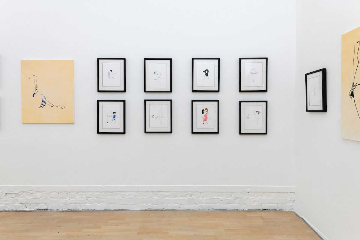Install photo of framed illustrations by Petite Luxures hung on a wall