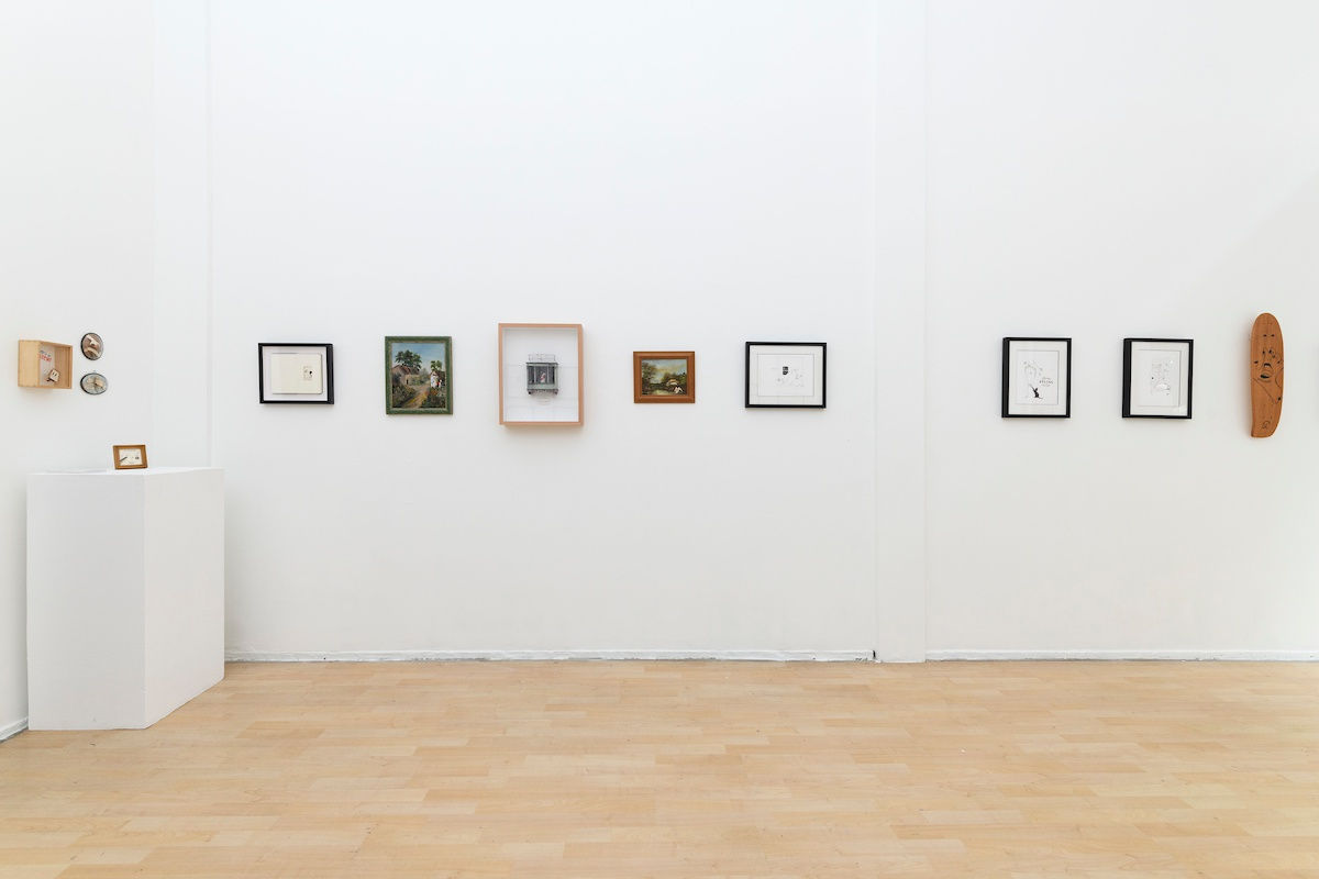 Install photo of framed illustrations by Petite Luxures hung on a wall