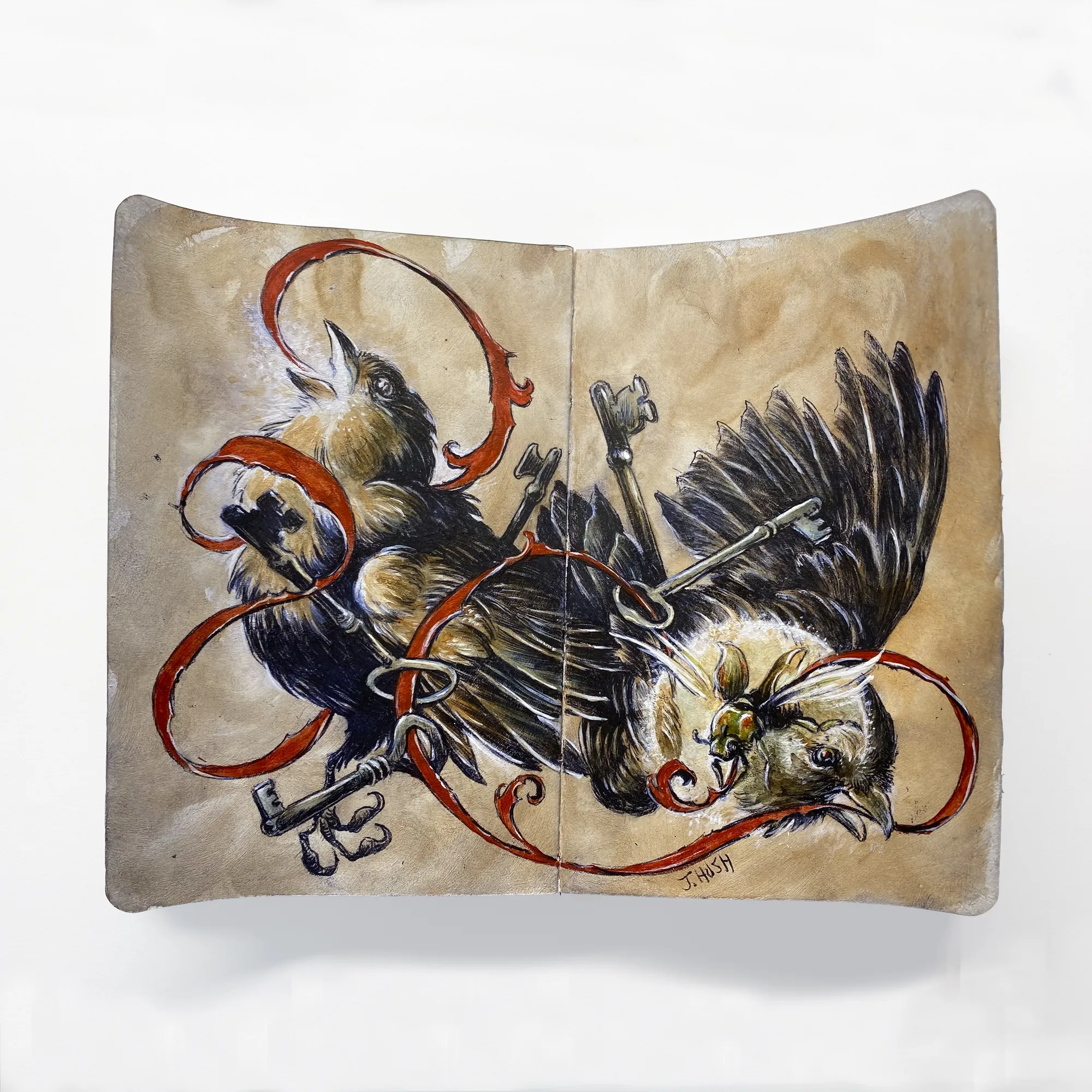 two crows with red ribbon holding keys wrapped around them