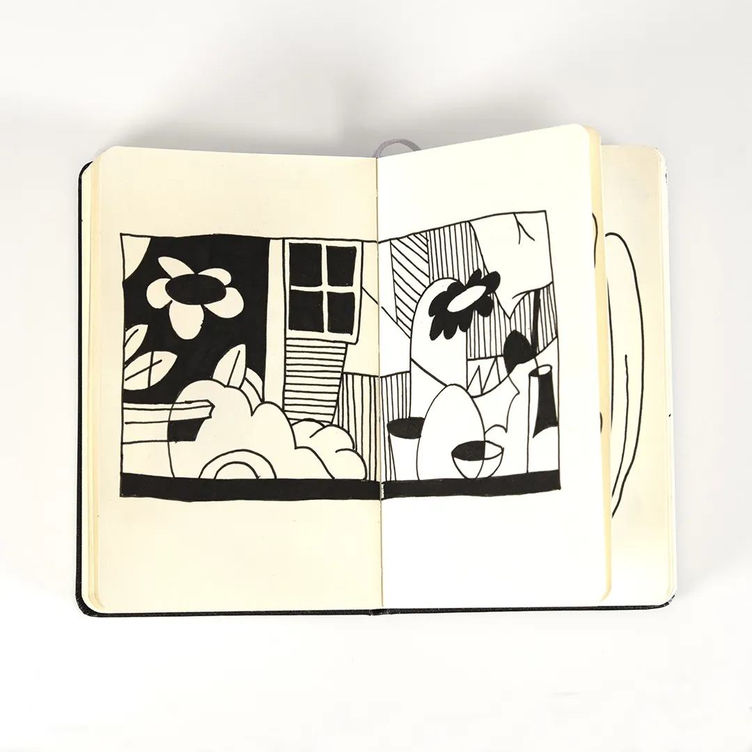 black and white drawing of flowers in a house made in a moleskin notebook