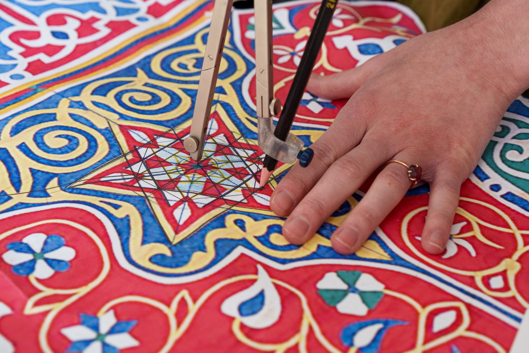 Yasmin Hayat in her studio working on the analysis of Lulu Lytle’s antique Egyptian tent panel. The analysis and breakdown of the geometric design in the tent panel informed the development of Yasmin’s Rumi pattern. The Rumi fabric is now available for purchase at Soane Britain. Image courtsey of Soane Britain.