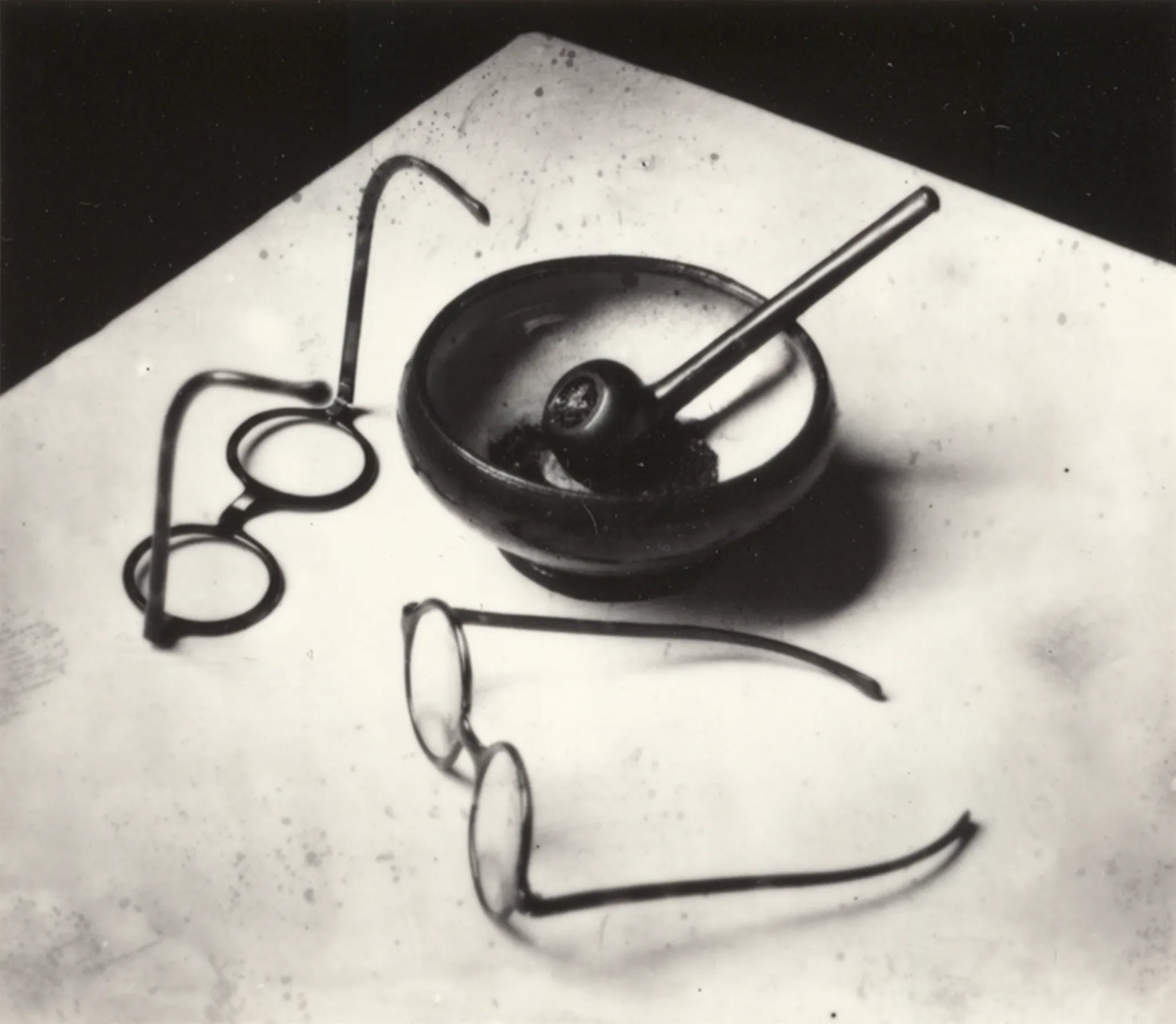 André Kertész (1894-1985) Mondrian's Pipe & Glasses, Paris, 1926 Gelatin silver print mounted to paper, printed c. 1981 Signed by artist on mount recto 3 x 3 1/2 in (7.6 x 8.9 cm)