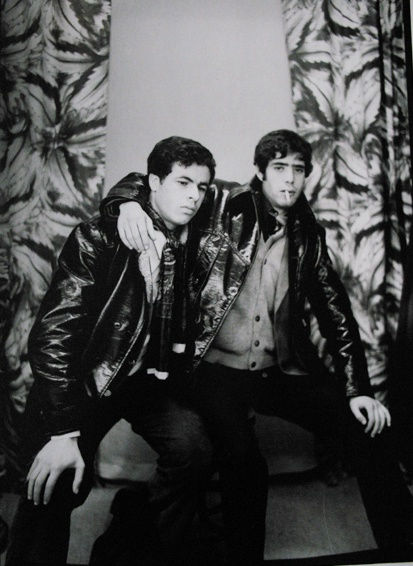 Black and white photograph of two men in a portrait studio