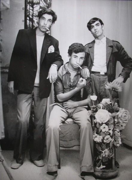 Black and white photograph of three men in a portrait studio