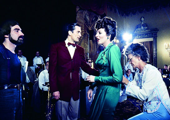 Color photograph of actors and Martin Scorsese on the set of a film