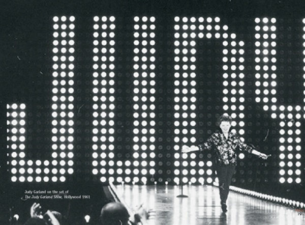 black and white photograph of Judy Garland walking on the stage of her show