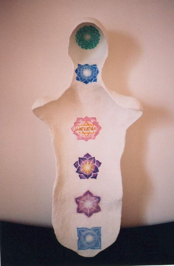 Plaster cast of a human torso with green, blue, pink, purple, and blue lotus