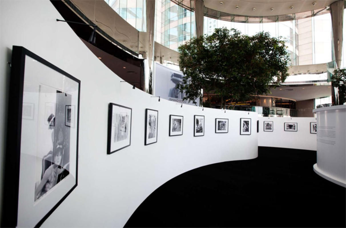 A row of black and white photographs of Coco Chanel taken by Douglas Kirkland in 1962 hanging on a wall of The Rotunda in Hong Kong