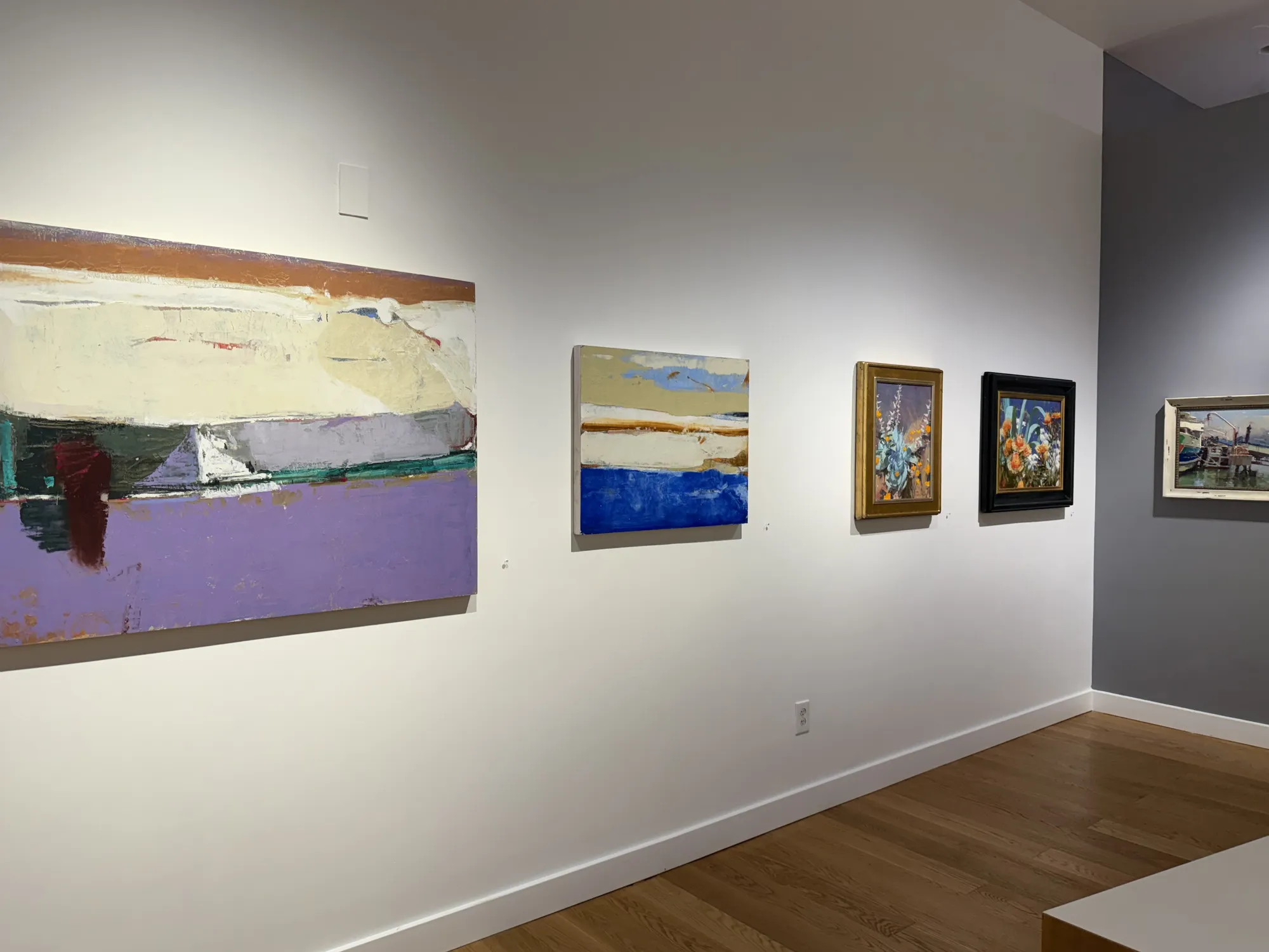 a gallery wall showing paintings by Randall Sexton