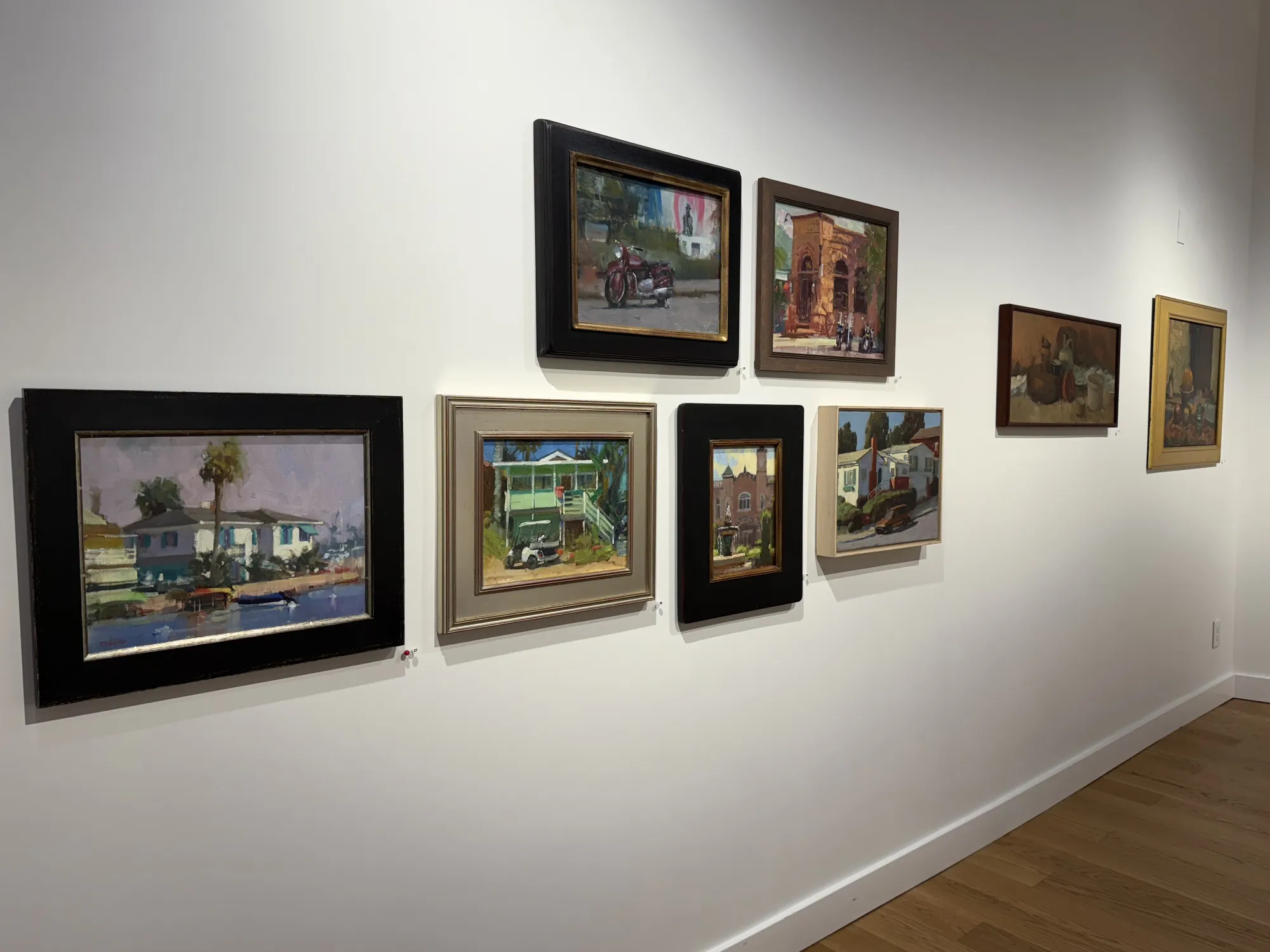 a gallery wall showing paintings by Randall Sexton