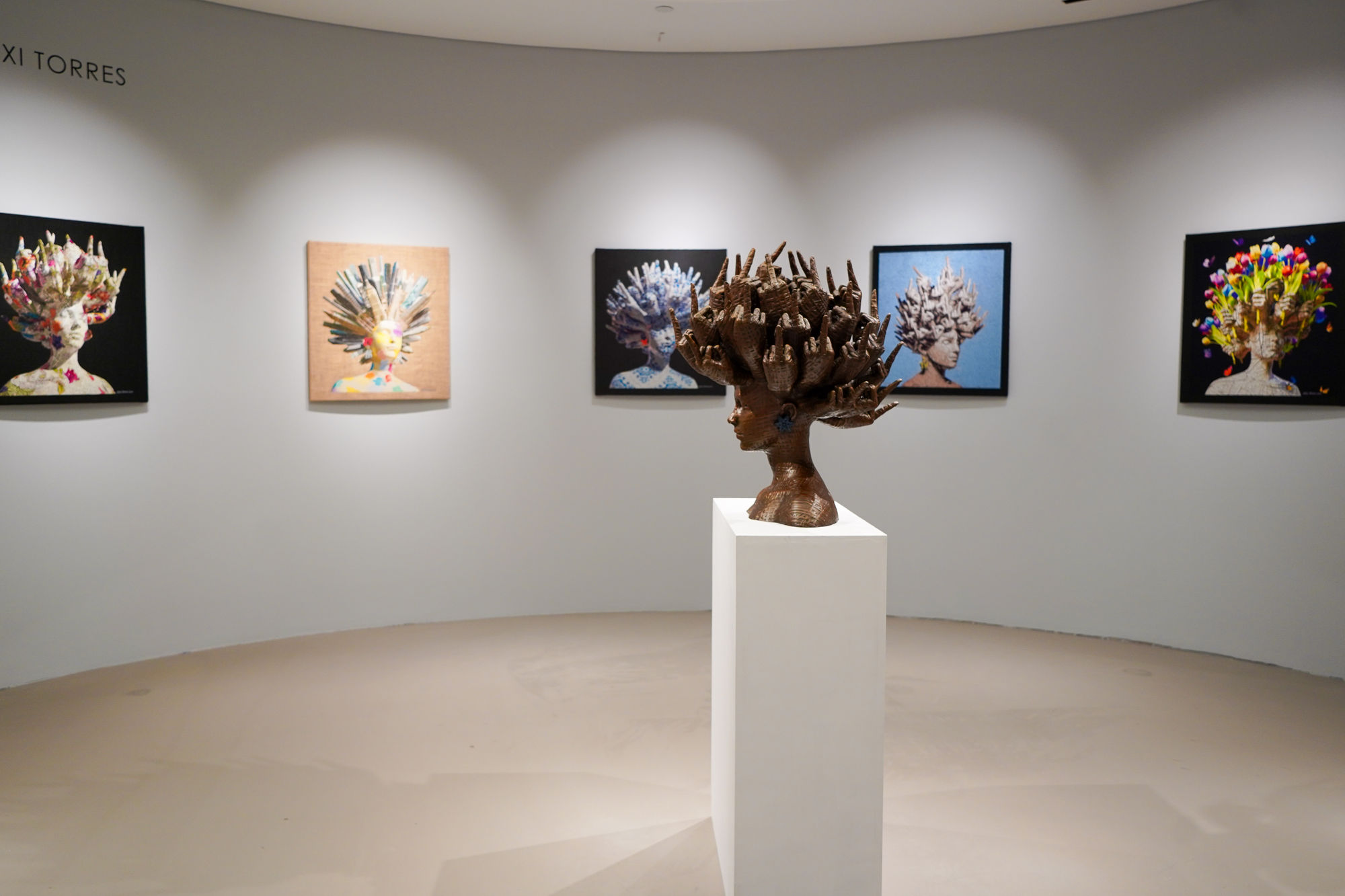 Alexi Torres bronze sculpture on display in Lenox Square's luxury wing next to Neiman Marcus, Gucci, Louis Vuitton.