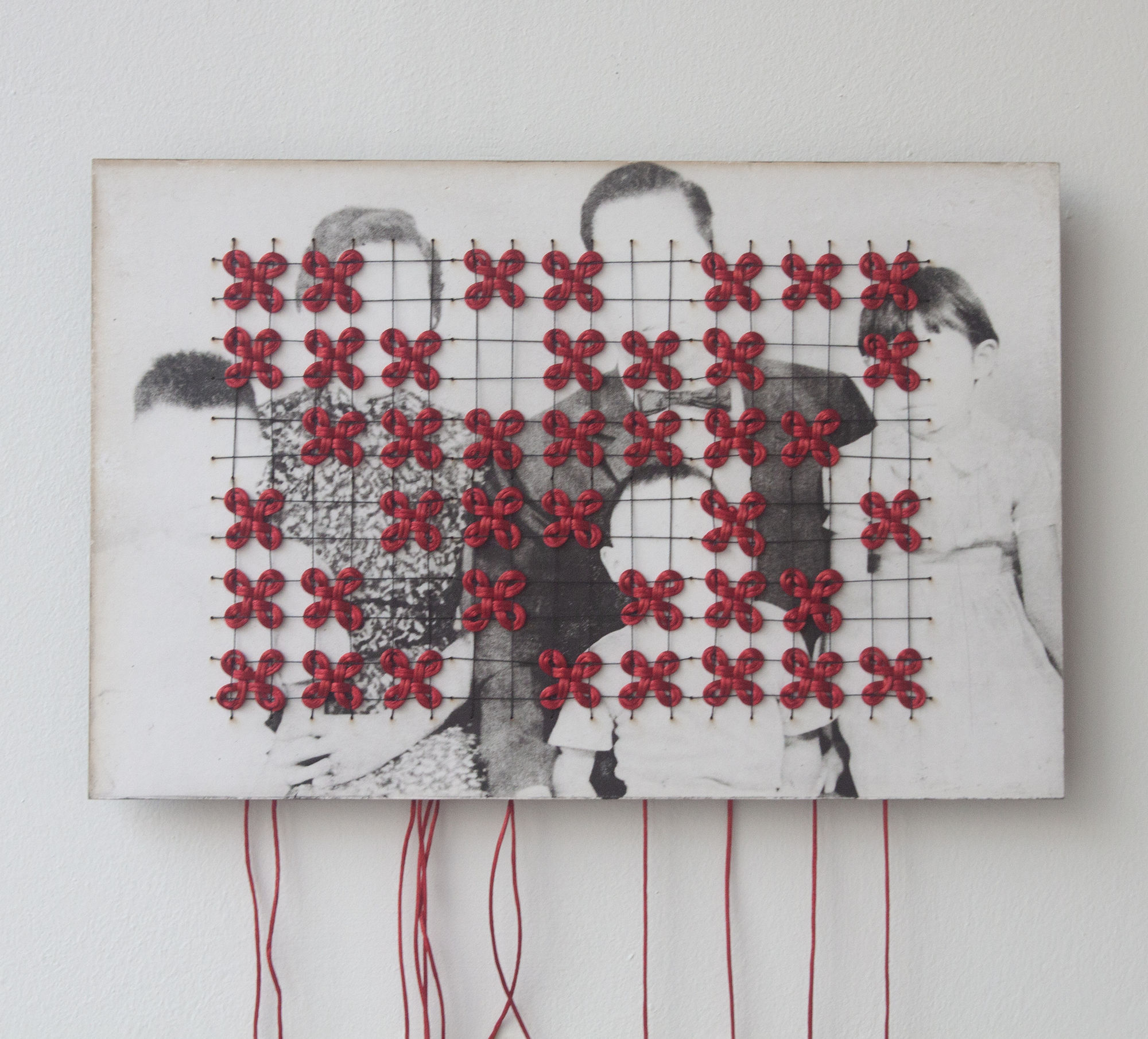 Choi Wong, Hierarchy of Five, 2025 Material Toyobo polymer etching of a found image on 4 mm poplar plywood, with red threads, yarn, and wooden beads, 29.3 × 19.3 cm
