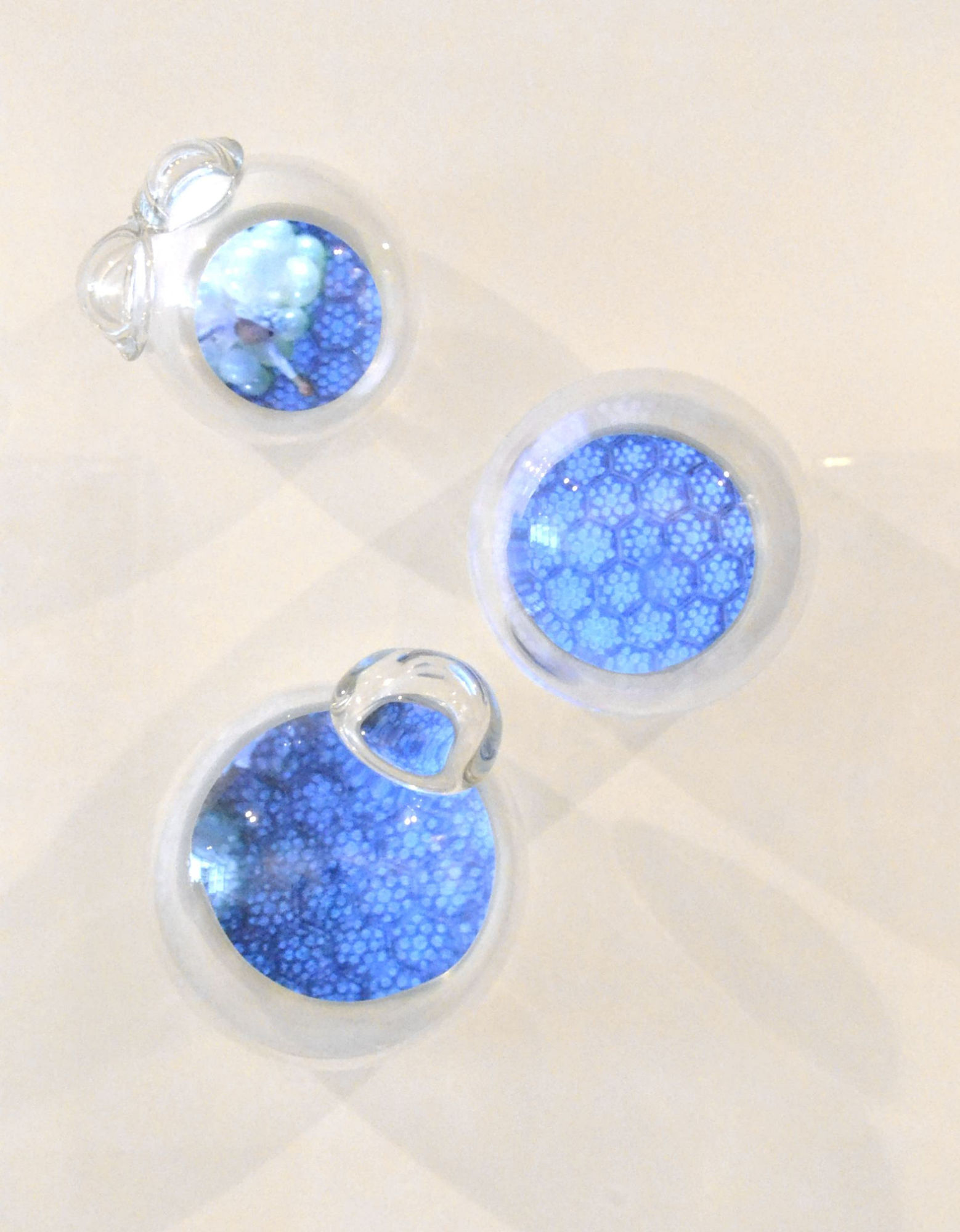 Triplebubble, 2013 Hand-blown glass bubbles, video screen, embedded in an acrylic pedestal, 3-Channel video composition, 5:55 minutes, looped