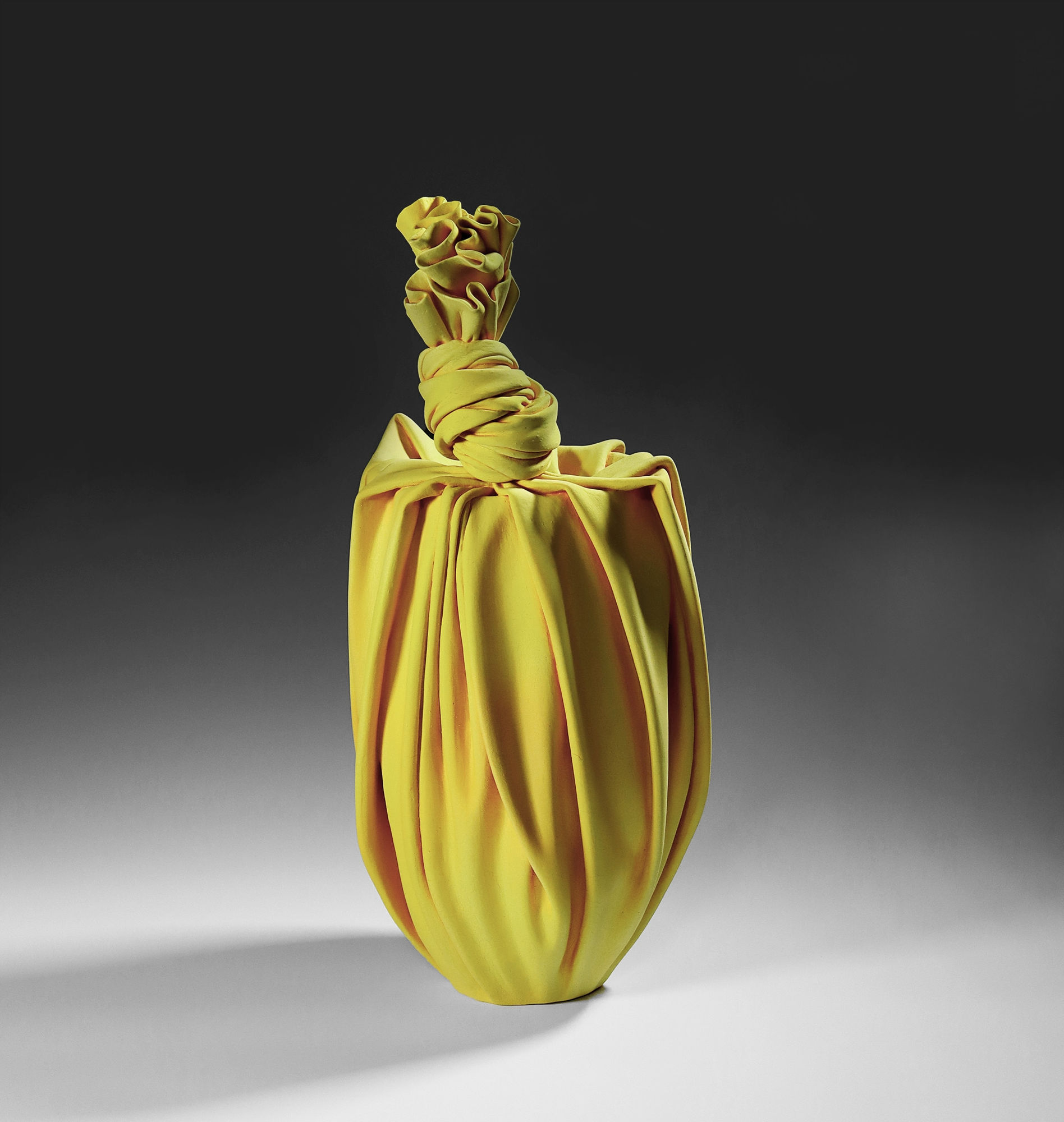 Tanaka Yū (b. 1989) Yellow sculpture in the shape of a knotted furoshiki (wrapping cloth) enclosing a conical vase 2020 Matte-glazed stoneware 20 7/8 x 10 1/4 x 11 in. Inv# 11723 SOLD