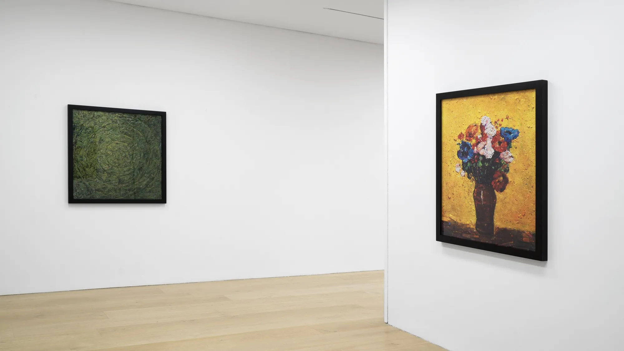 Installation view of a gallery with framed photo collages by Vik Muniz