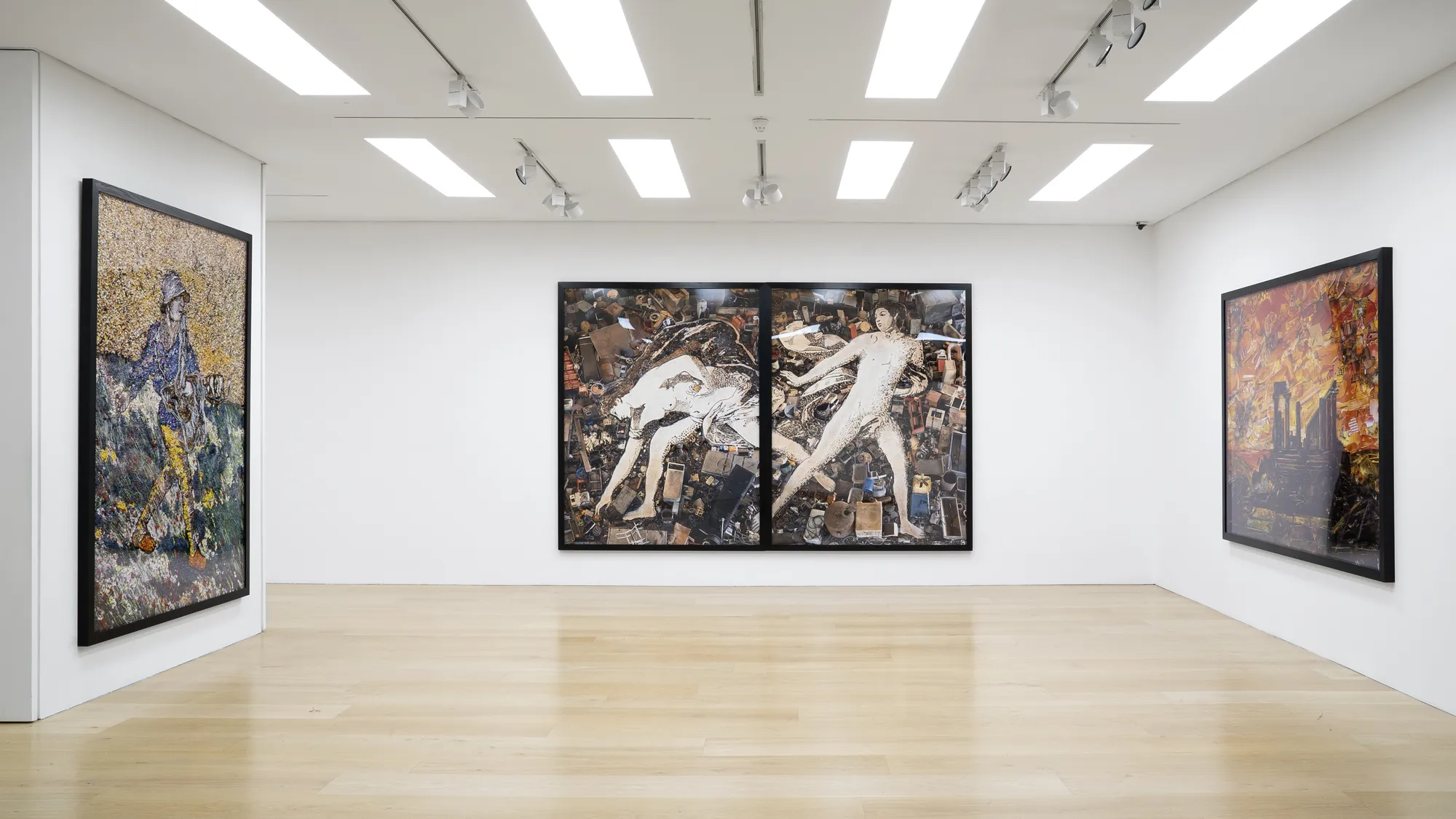 Installation view of a gallery with framed photo collages by Vik Muniz
