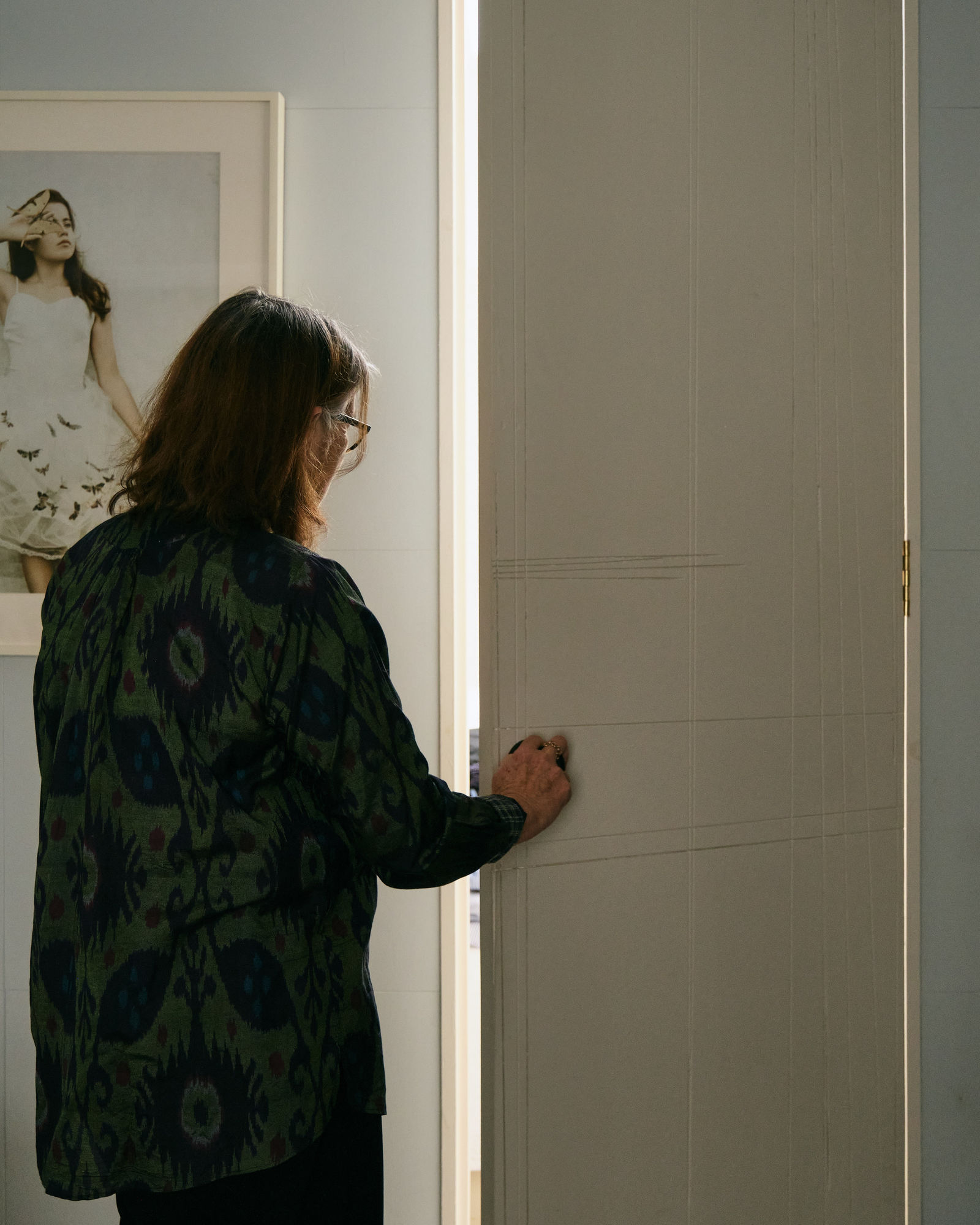 Christine opens the door to the secret guest room that was once Stuarts woodwork bench